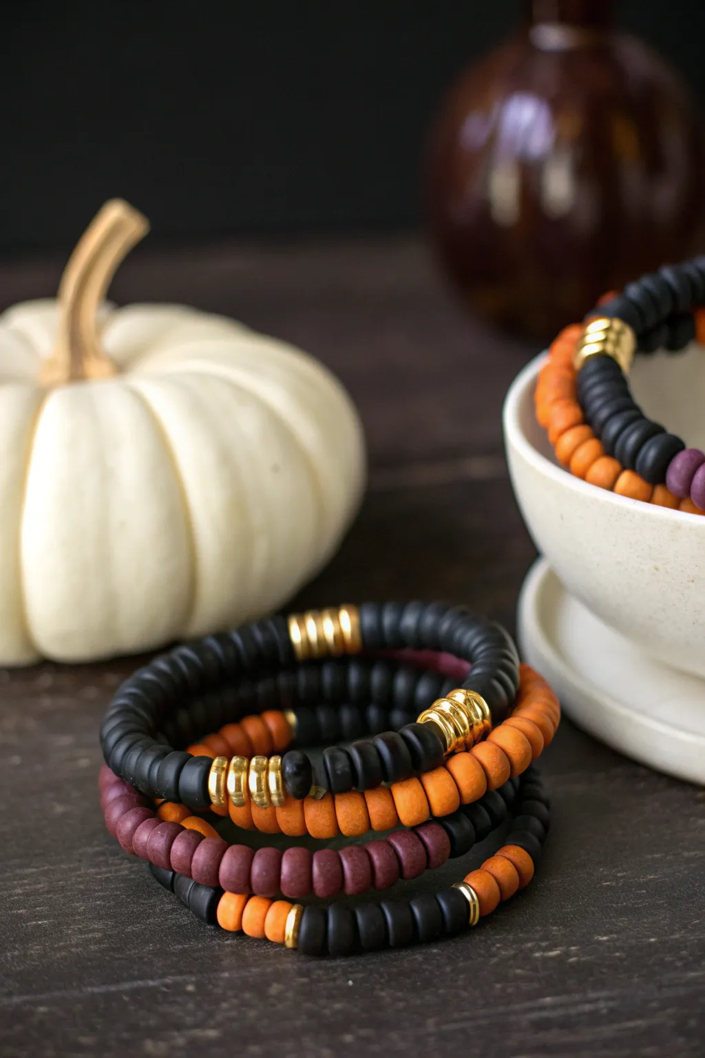 Moody Halloween fall bracelet stack in black, orange, purple and cream with a tiny white pumpkin