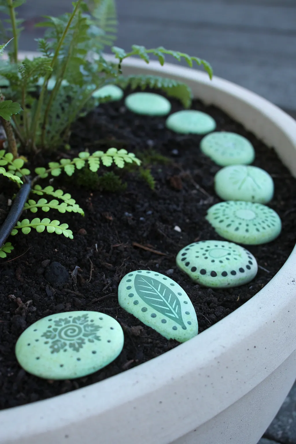 Mini fairy garden path pebbles glow softly at dusk, simple stamped patterns for easy DIY magic.