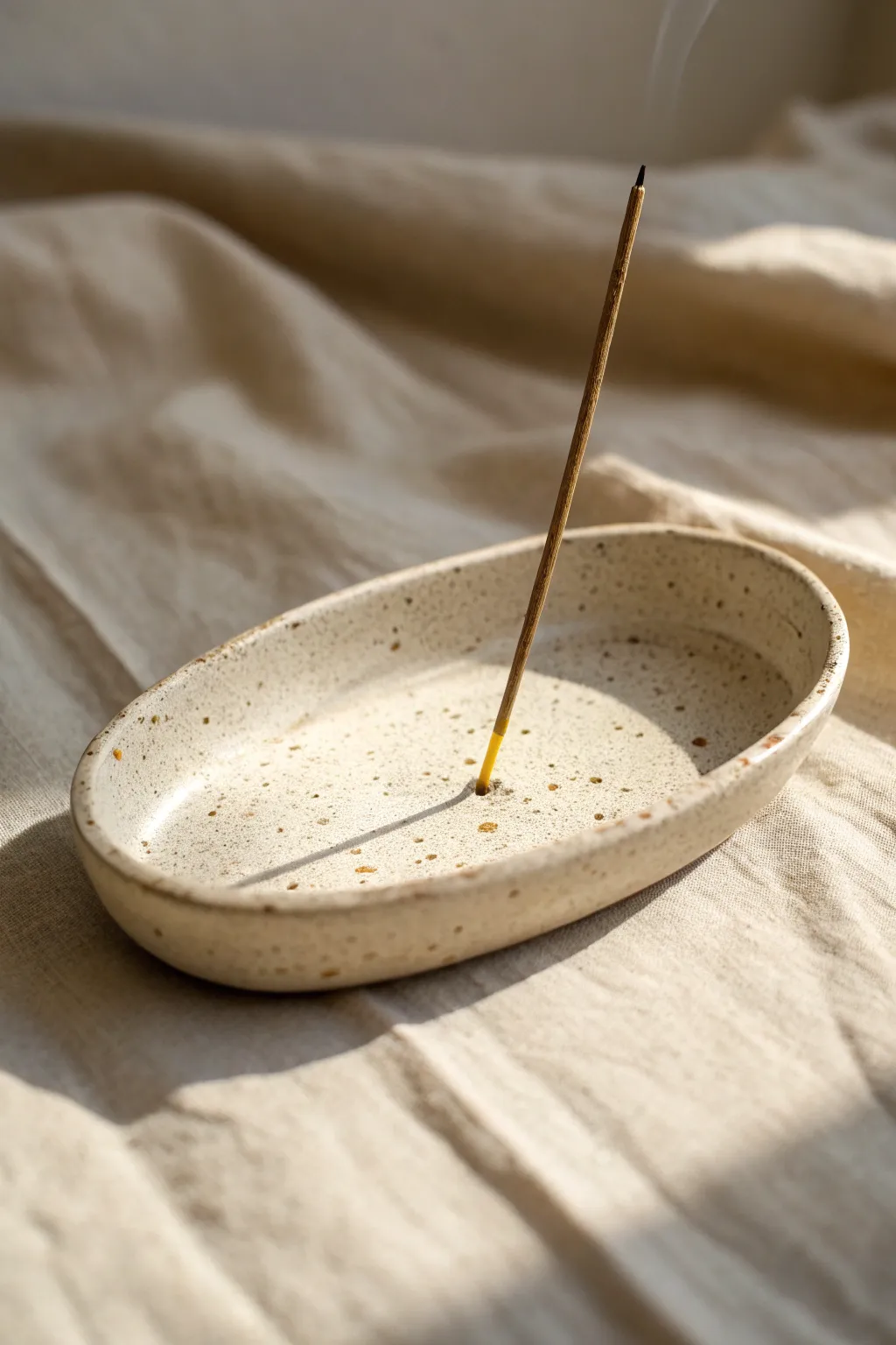 Simple handmade clay incense holder in soft neutrals, minimalist and calm with natural texture.