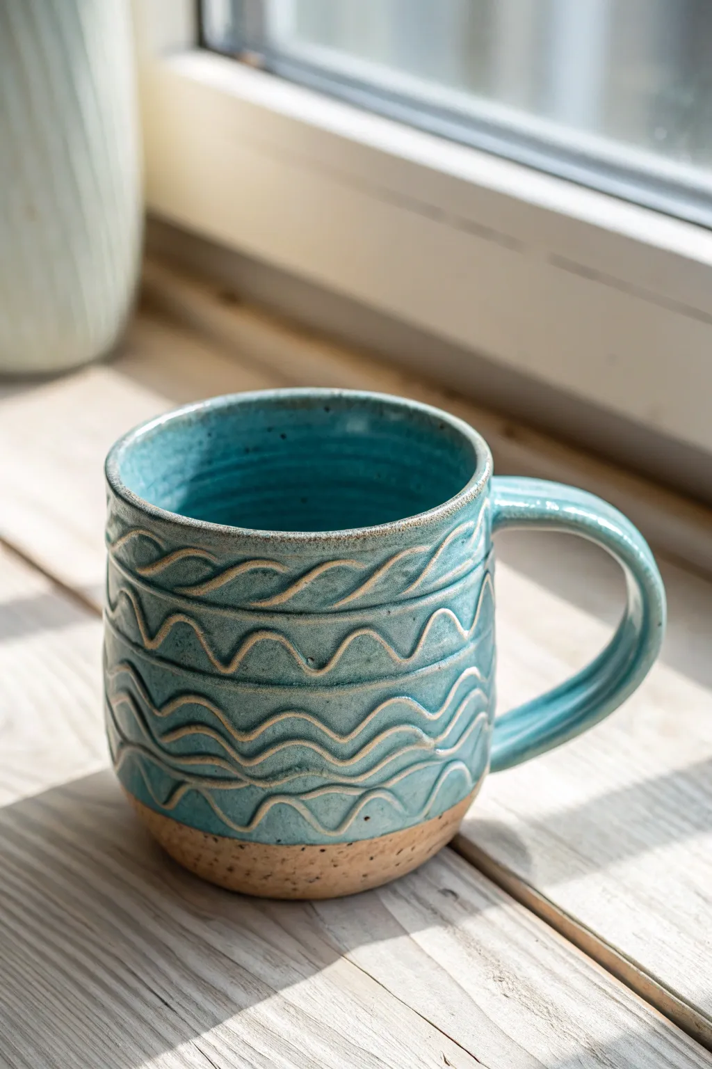 Carved wave-texture ocean mug in layered blues, a simple middle school clay project