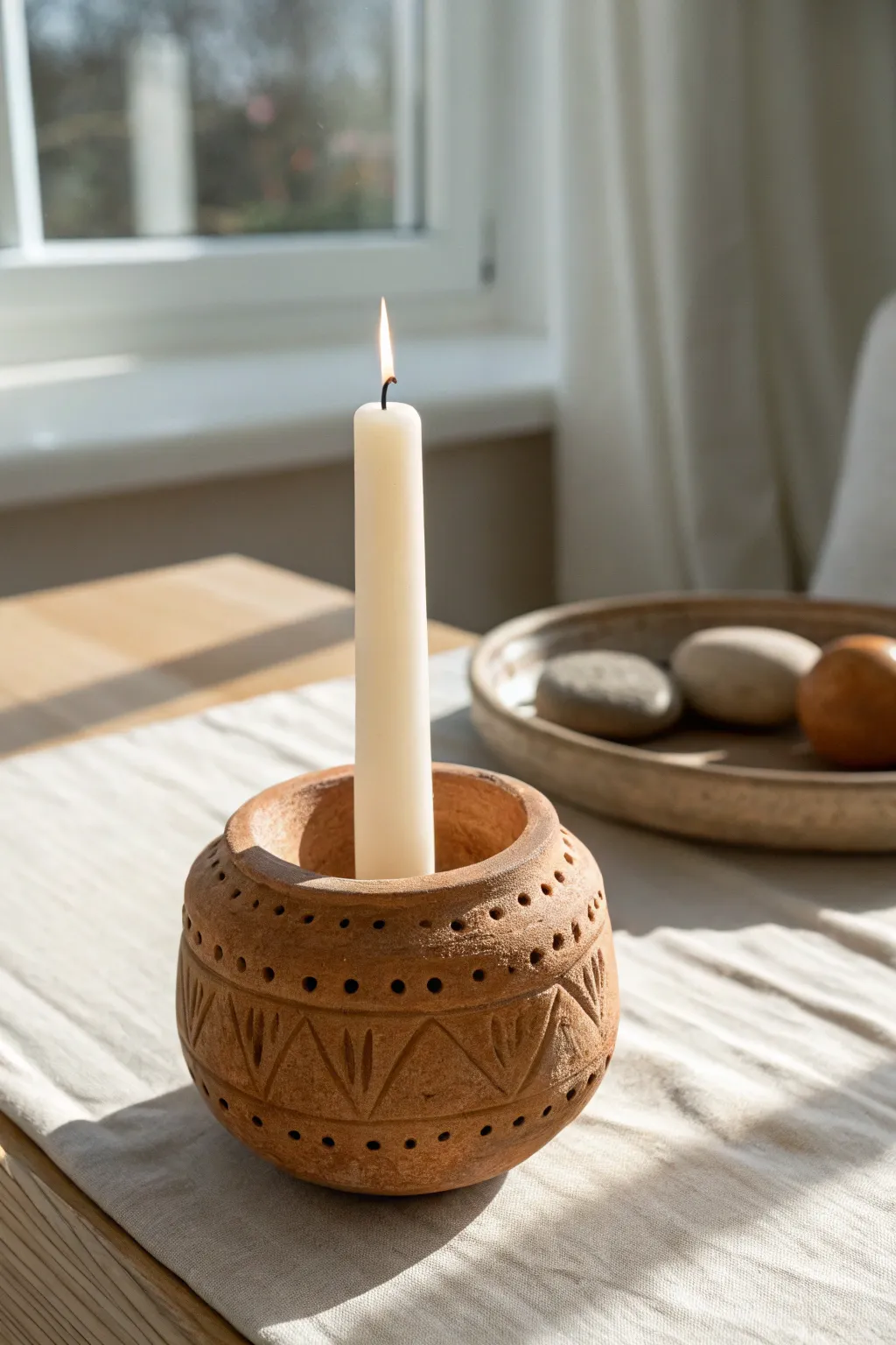 Simple carved clay candle holder with a taper candle, perfect beginner-friendly pattern practice.
