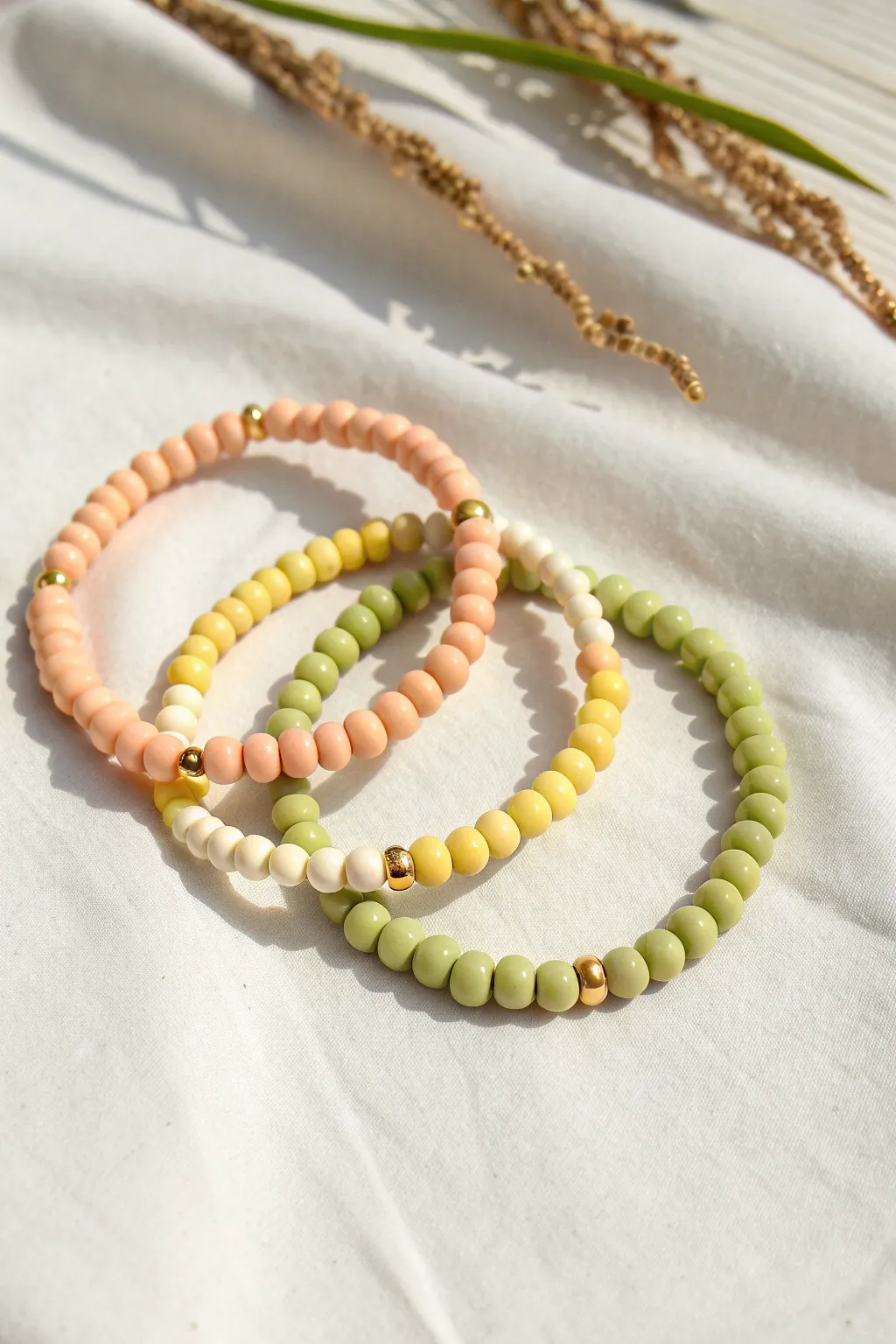 Fruit sorbet preppy clay bead bracelet stack in peach, lemon, kiwi with chic gold accents.