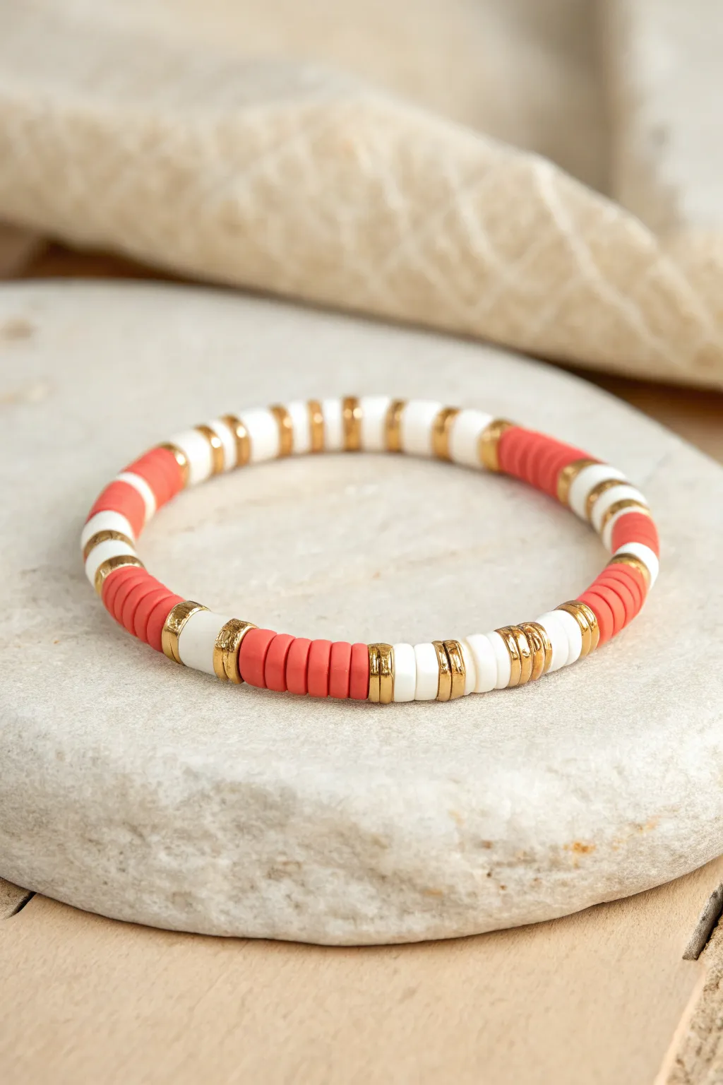 Rugby stripe heishi bracelet in crisp bands with a gold spacer, minimalist preppy chic.