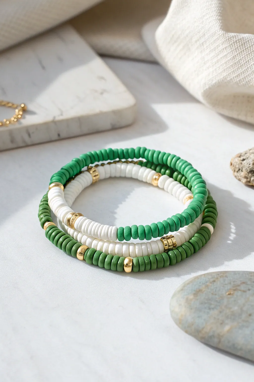 Tennis-inspired green and white heishi bracelet stack with gold spacers, clean and sporty