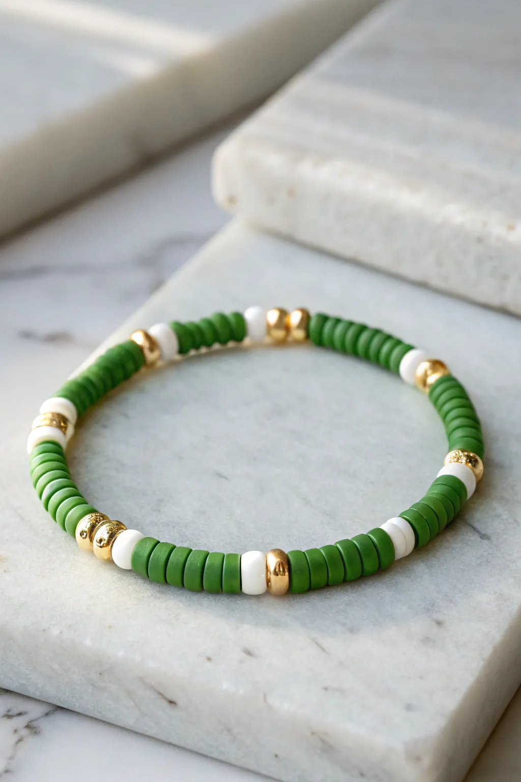 Tennis club chic: grass-green and white heishi bracelet with delicate gold spacer accents.