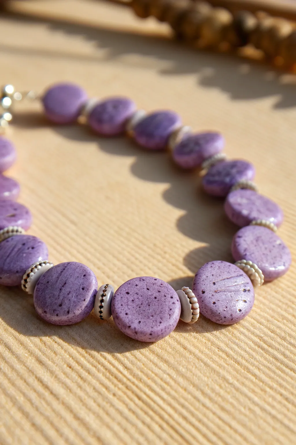 Textured purple disc bead bracelet with matte speckles in a clean Scandinavian boho style.