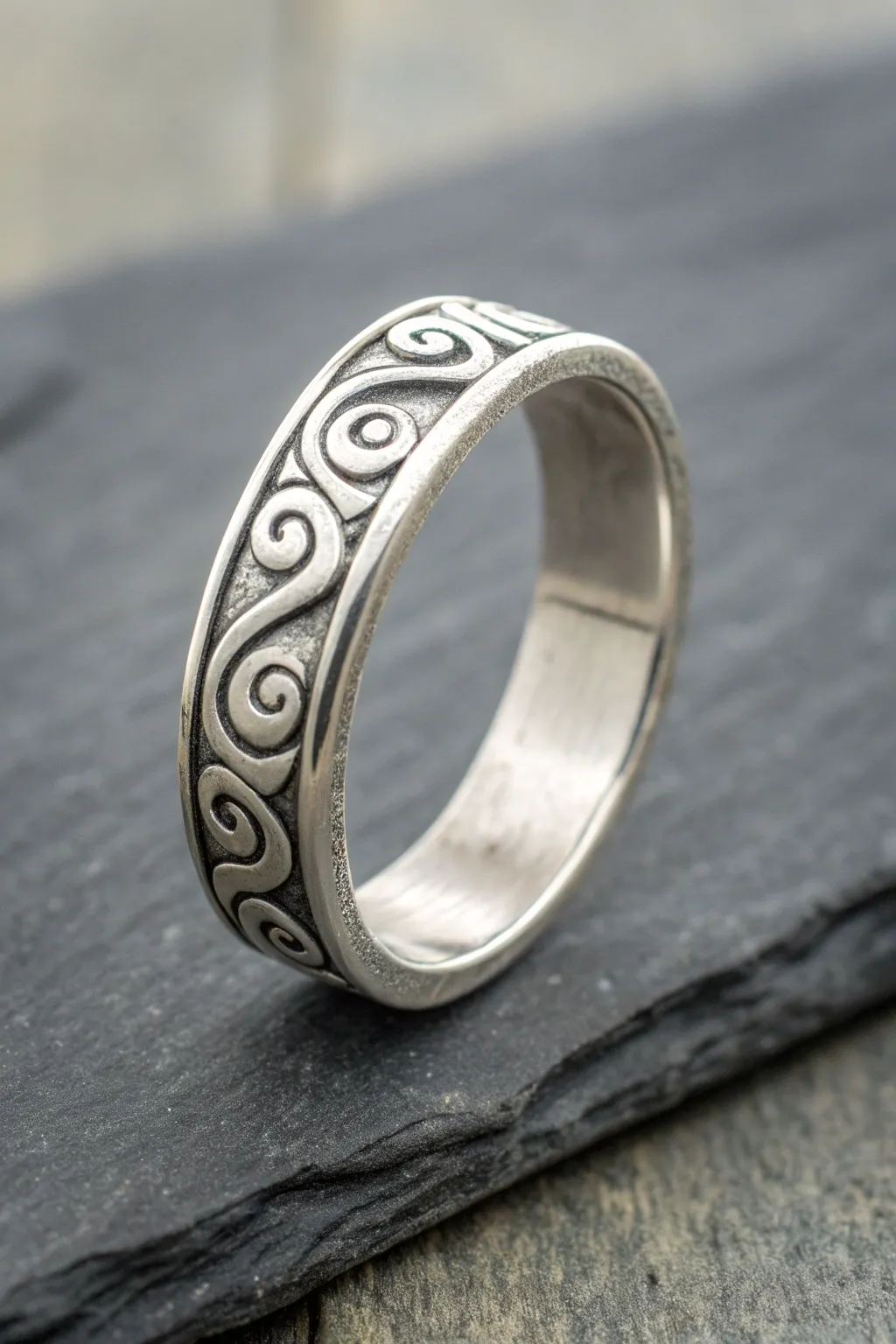 Syringe-line swirls add playful texture to this minimalist silver clay ring on dark slate.