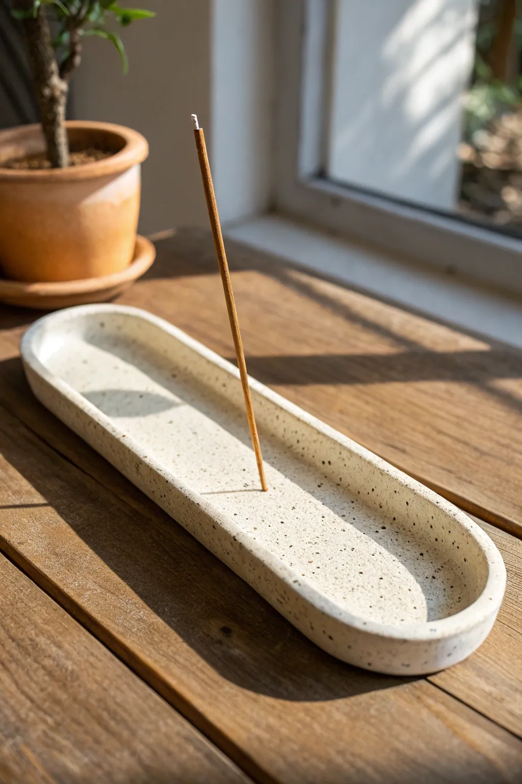 Minimal curved slab incense holder with a raised lip, calm Nordic tones and clean contrast