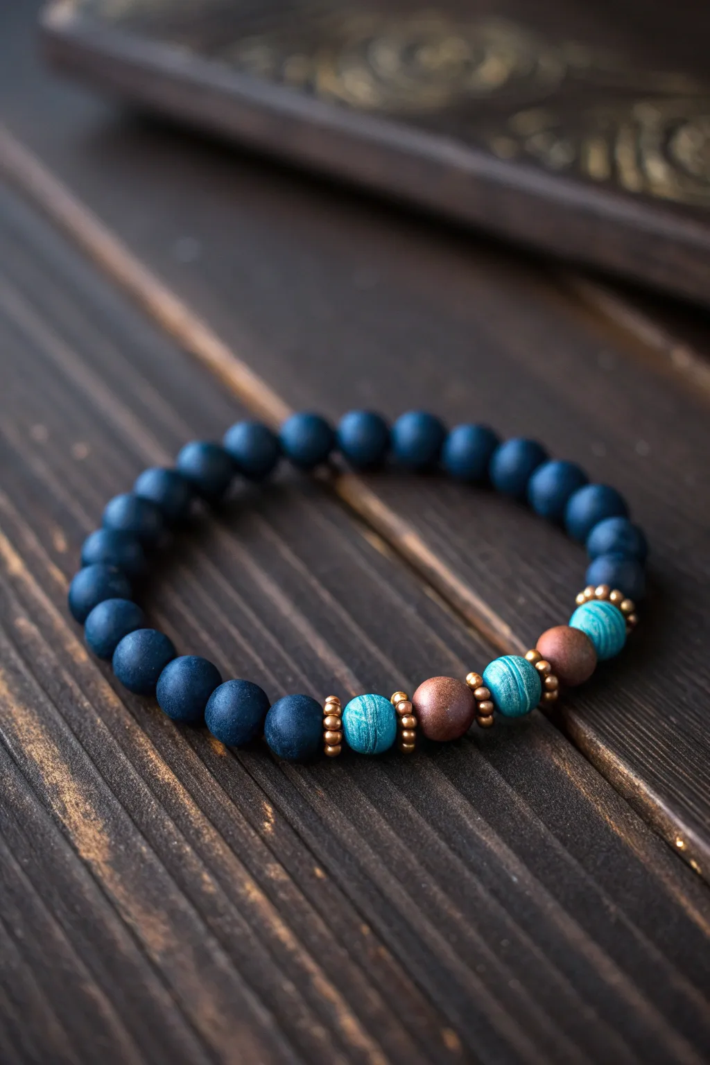 Desert night clay bead bracelet in deep navy with turquoise pops and warm copper tones