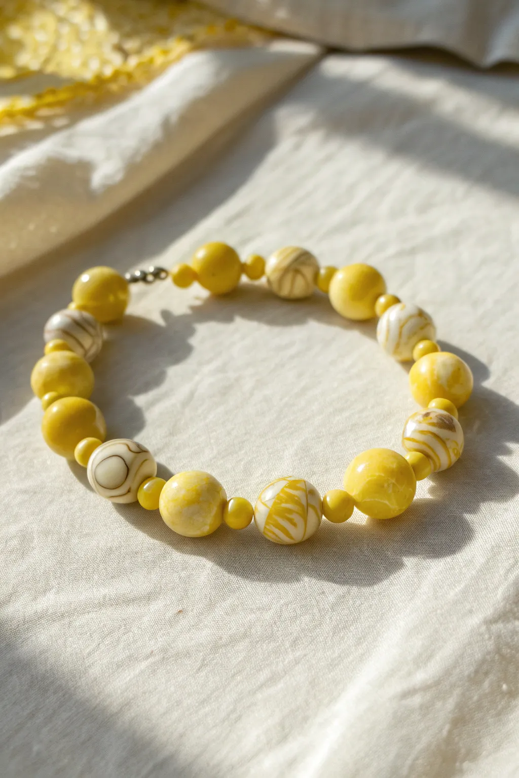 Marbled yellow-and-white focal beads add a sunny twist to this simple clay heishi bracelet