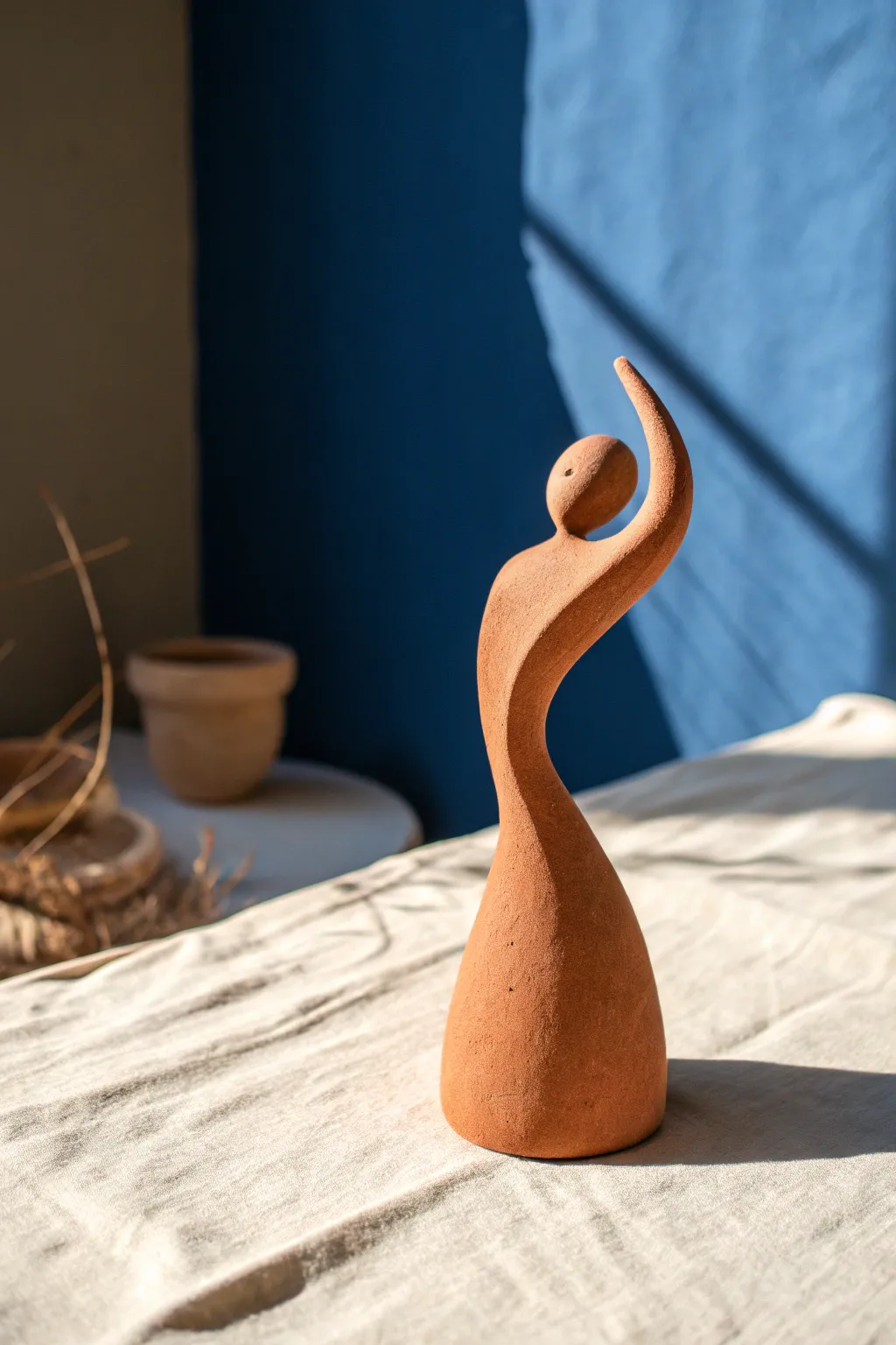 A minimalist abstract clay gesture sculpture with bold shadows that make the form feel alive