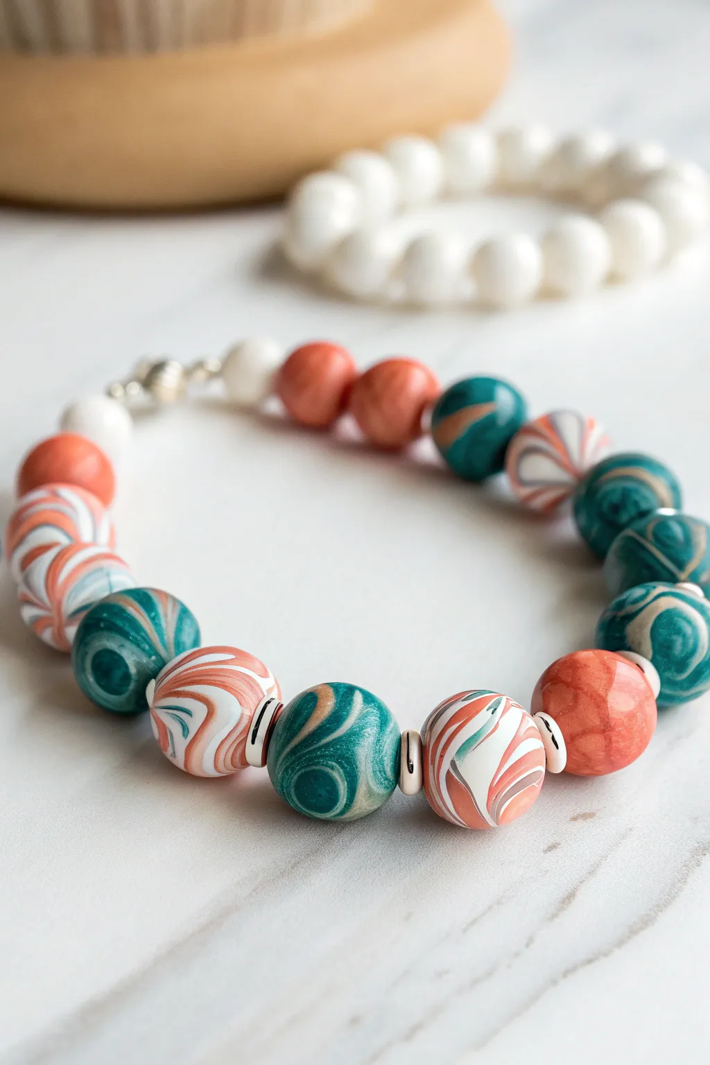 Bold marbled swirl beads with clean heishi discs for a modern minimalist clay bracelet statement