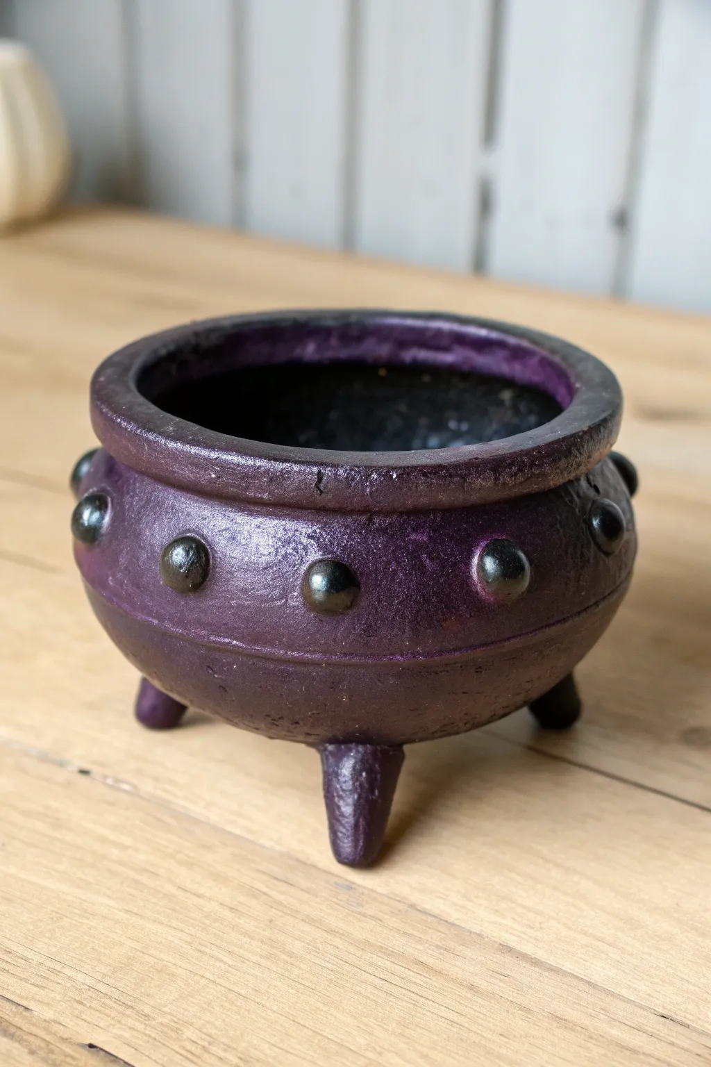 Spooky eyeball cauldron ashtray in glossy purple and black, a bold air dry clay Halloween idea.