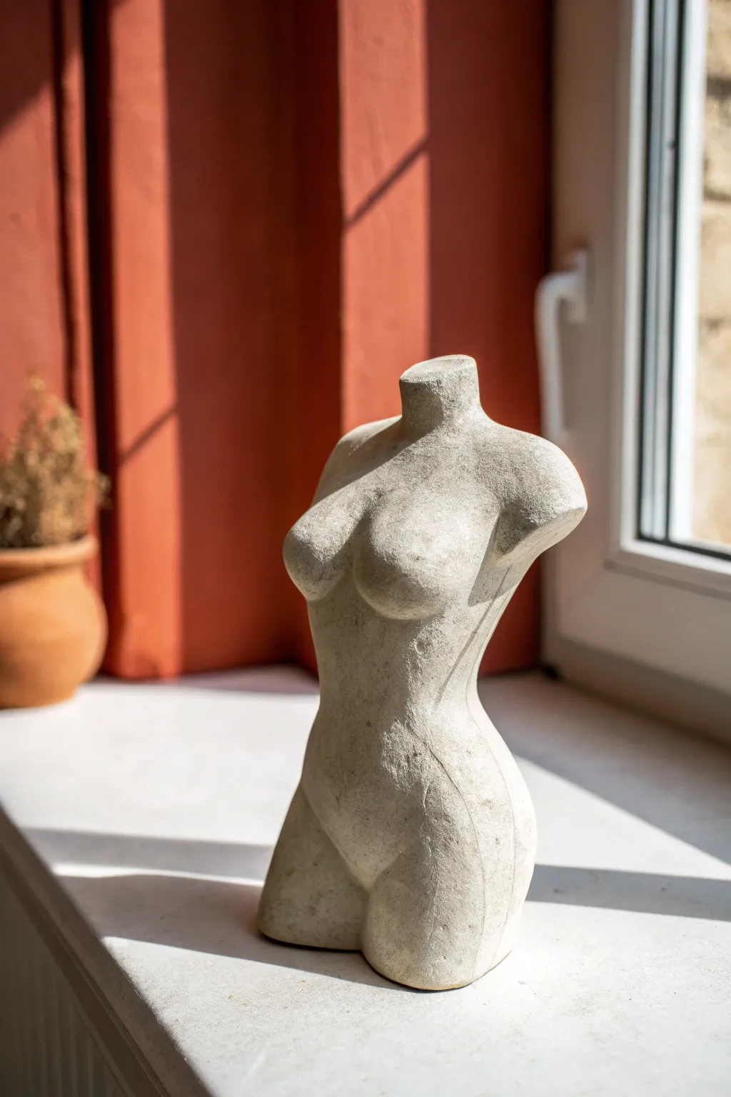 Modern mini air dry clay torso with matte stone look, set in soft shadows for a calm sculptural mood.