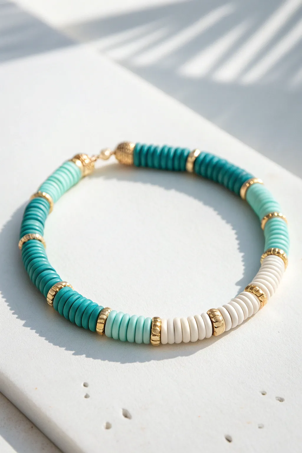 Smooth teal-to-seafoam ombre clay heishi bracelet for a minimalist, boho-inspired look.