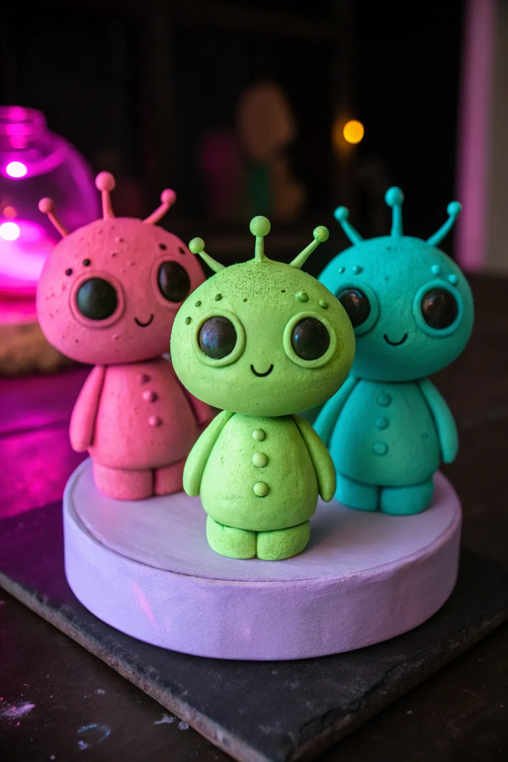 Neon glow alien trio, a playful cartoon clay crew that pops against moody minimalist styling.