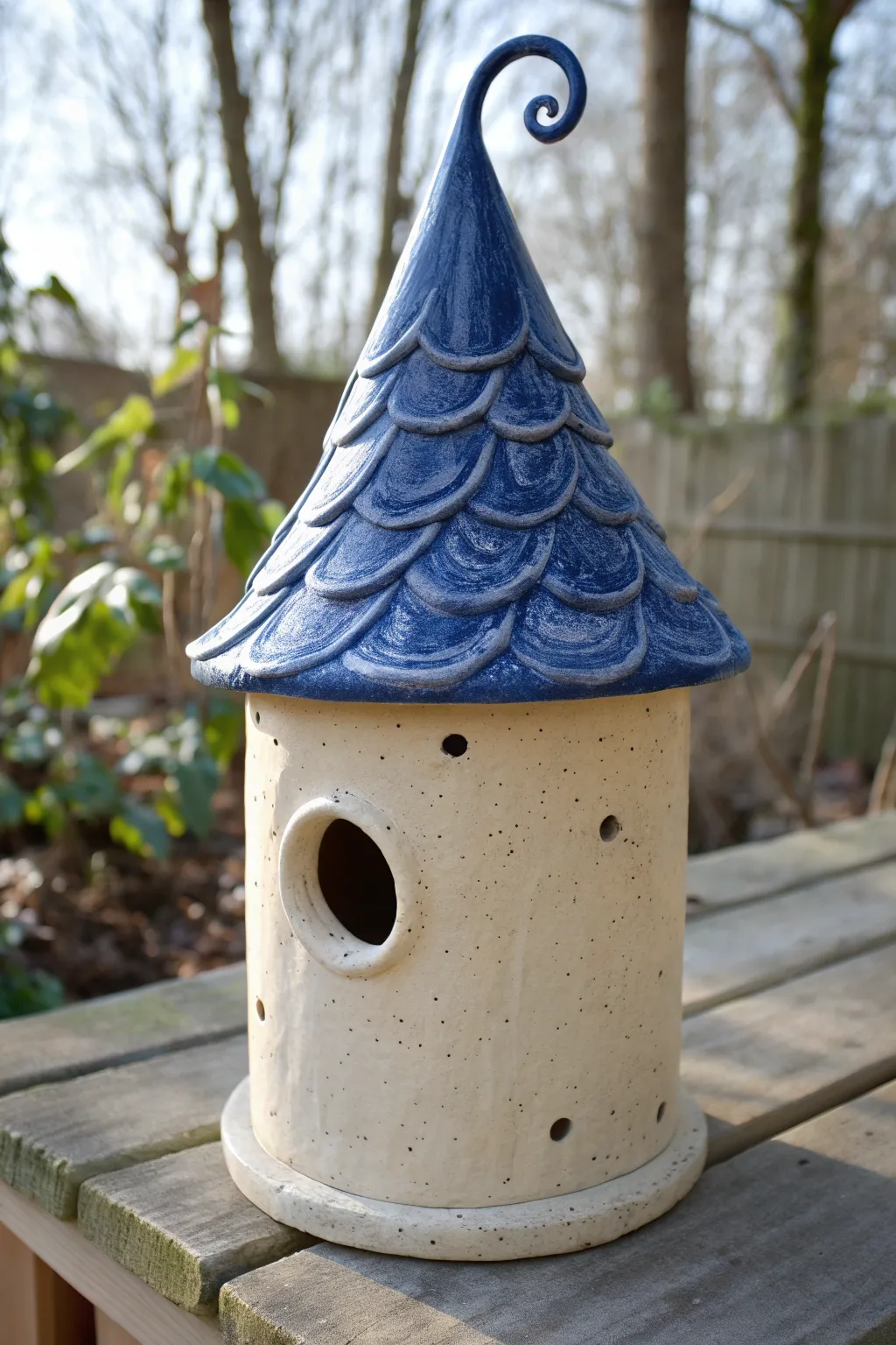 Storybook charm in clay: a crooked witch-hat roof birdhouse in bold glaze and calm minimal style