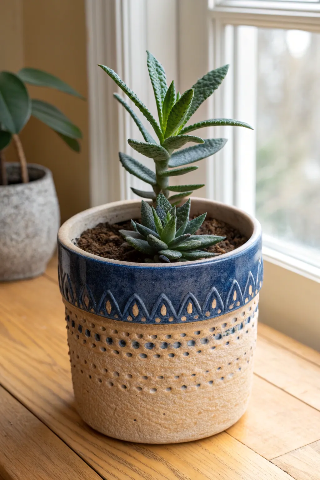 Bold gouged divots and pooled glaze turn this simple planter into a tactile statement piece.