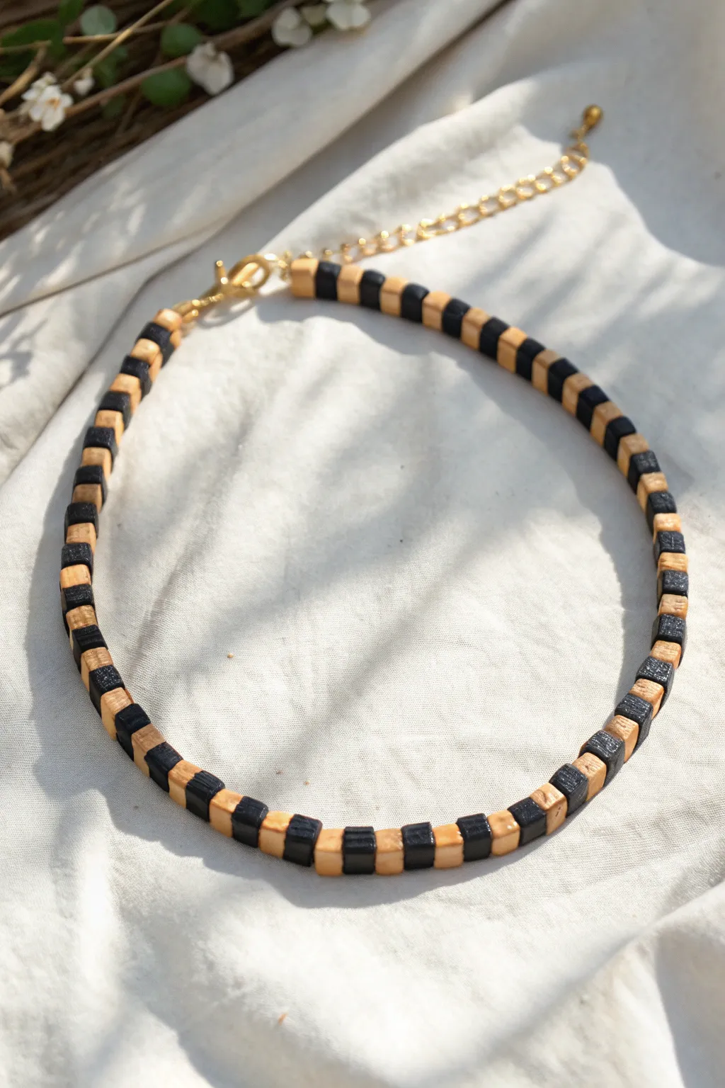 Bold checkerboard clay bead choker in matte black and sand tones, minimalist yet boho chic