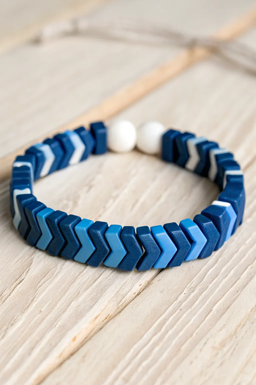 Geometric blue chevron clay bead bracelet with crisp white breaks, minimal, bold, and handmade.