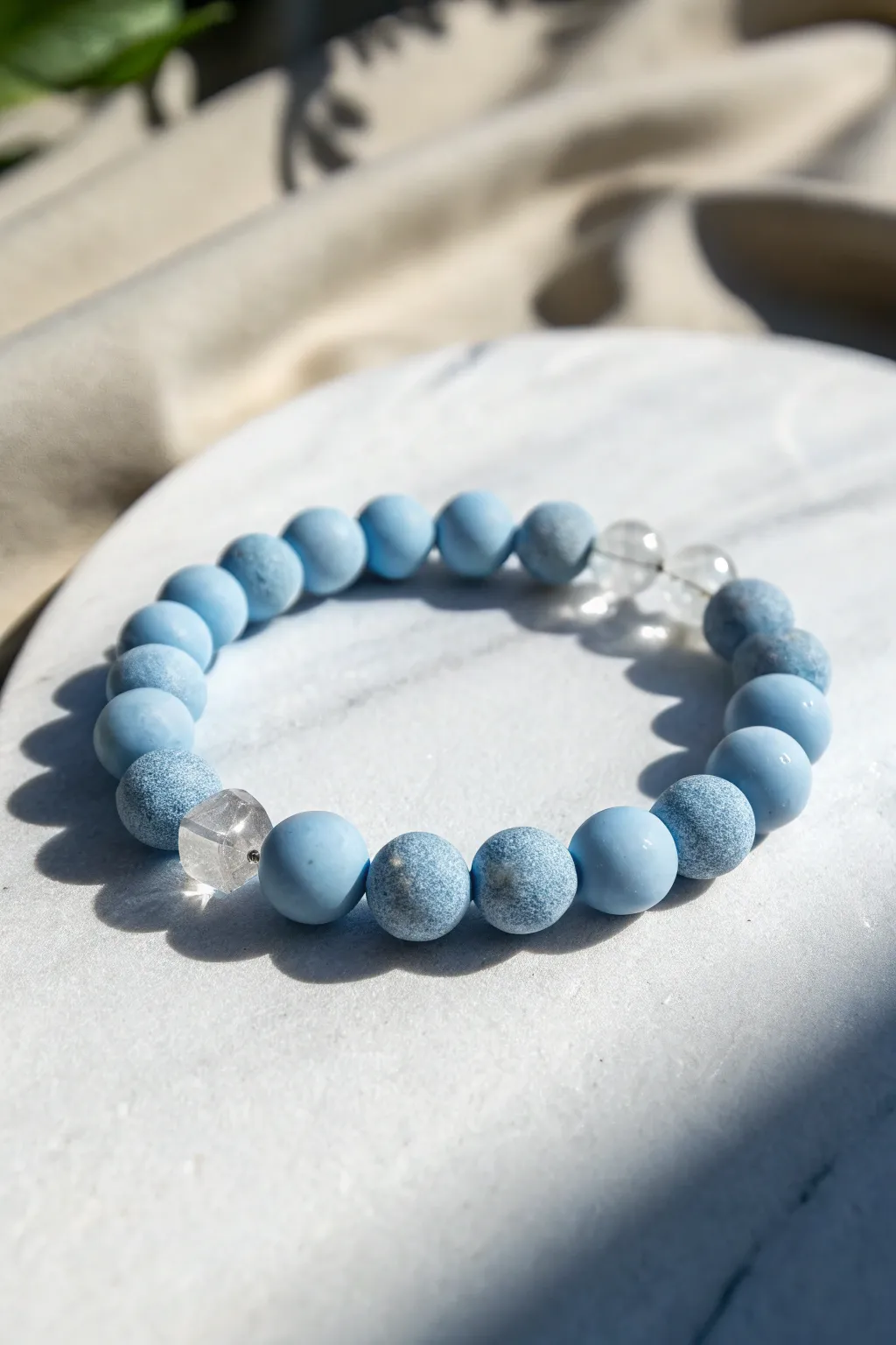 Icy blue clay beads with clear accents for a crisp, frozen look that feels calm and handmade.