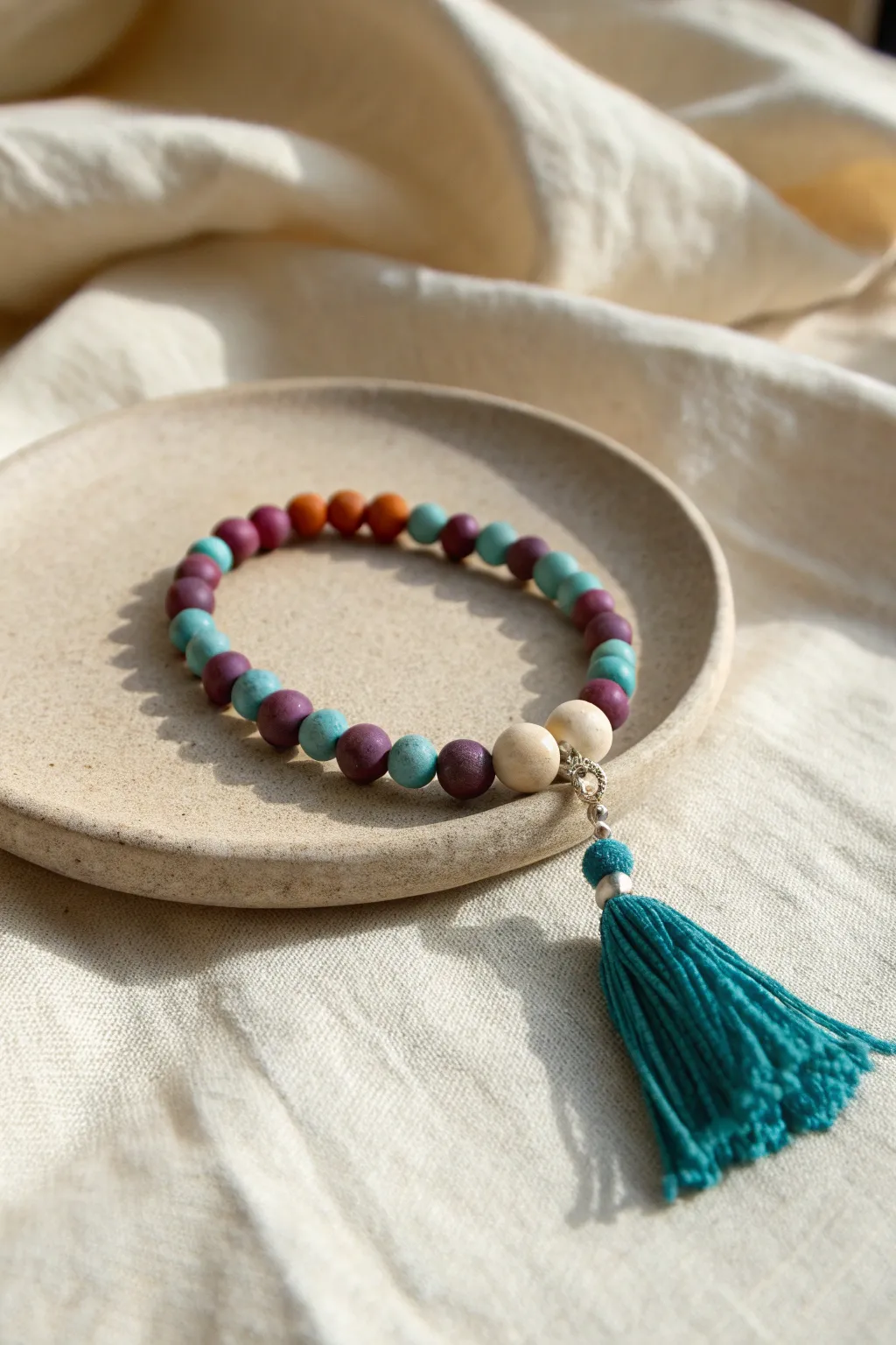 Teal tassel meets teal-and-purple clay beads for a bold, no-white color story
