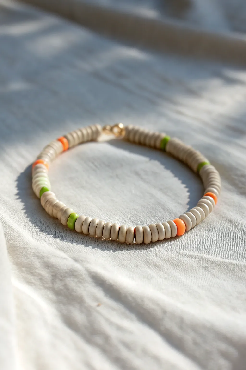 Muted neutral heishi bracelet with tiny neon accents for an unexpected pop of color.