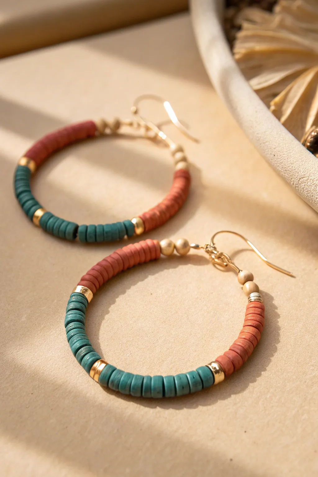 Textured heishi clay beads add depth and contrast to a simple hoop earring in bold earthy tones