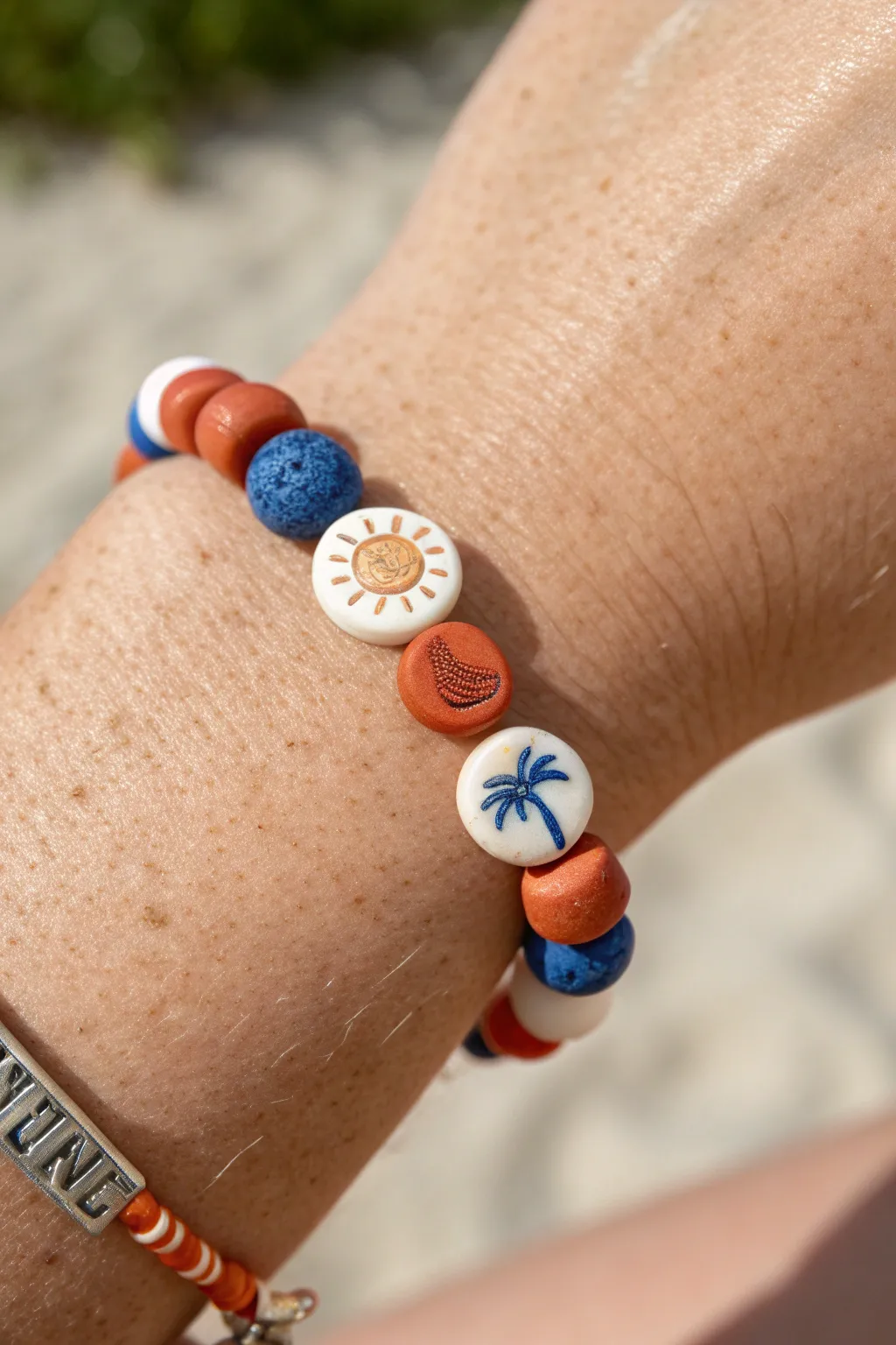 Handmade summer clay bracelet with mini sun, wave, and palm charm beads in bold minimalist style.