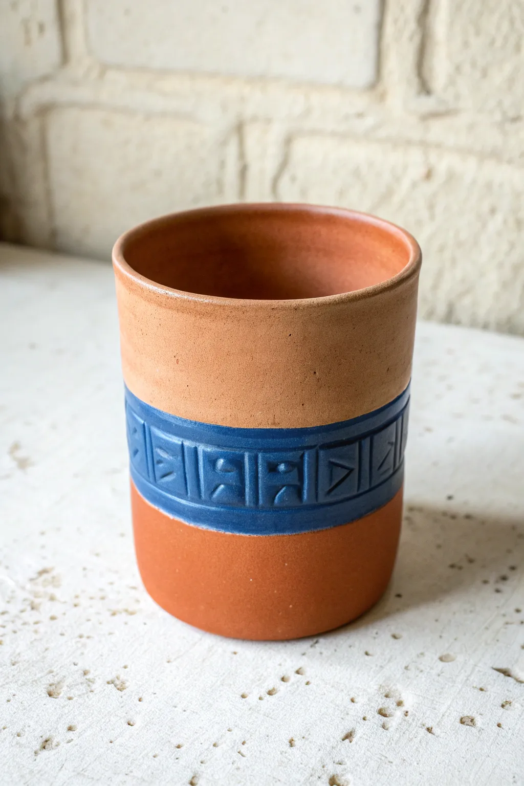Bold carved lettering-style band on a minimalist clay cup, an easy carving idea with handmade charm.