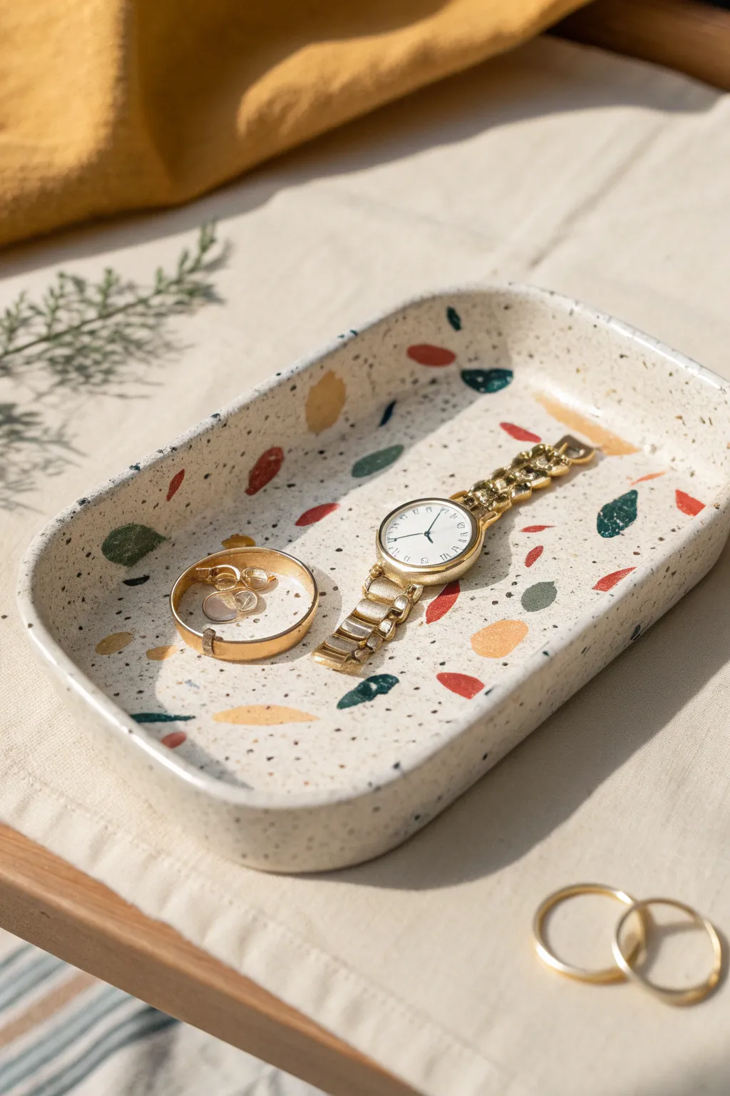 Terrazzo-speckle clay trinket tray with bold confetti chips, perfect for rings and a watch.