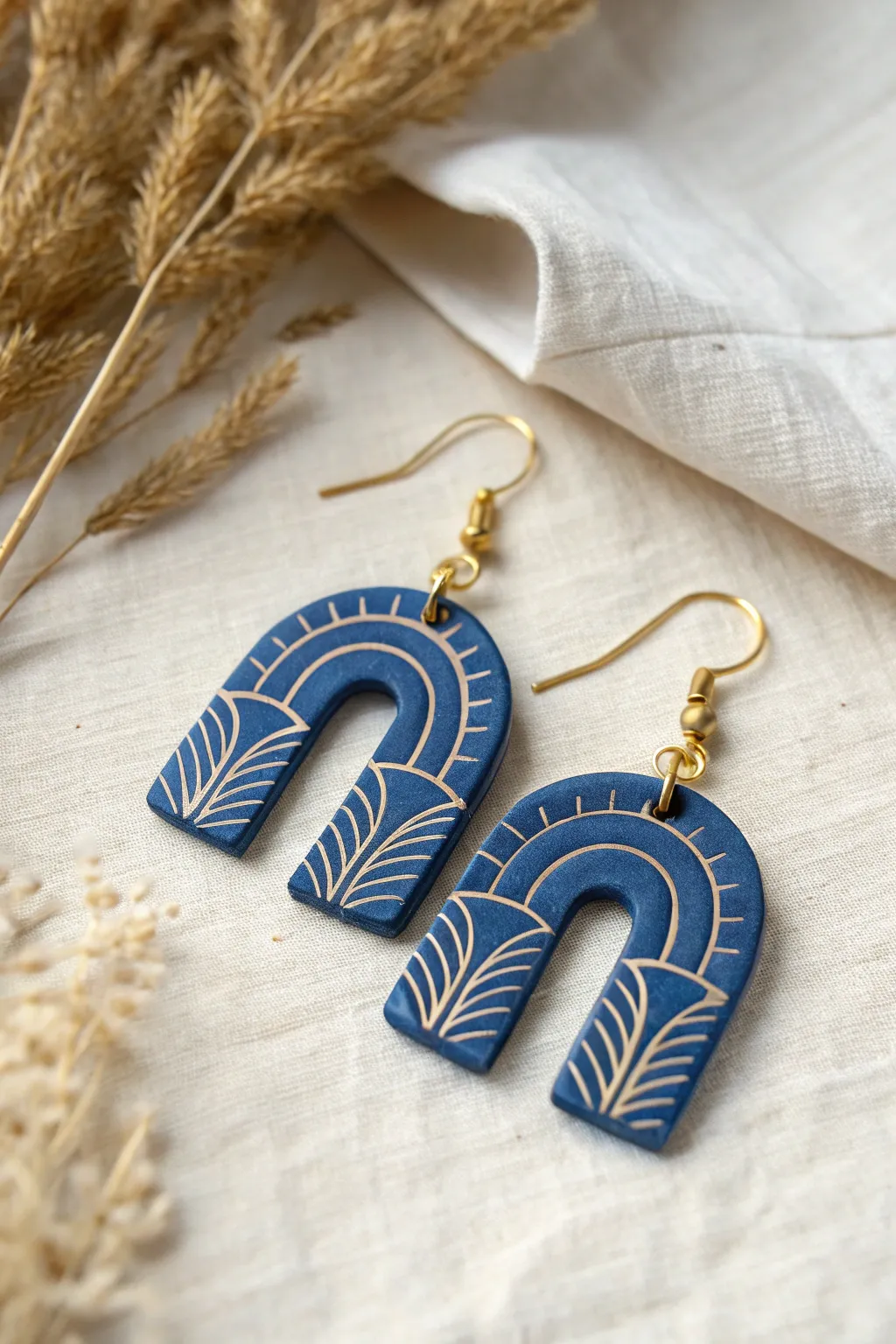 Stamped clay earrings with a soft painted wash that makes every raised detail pop