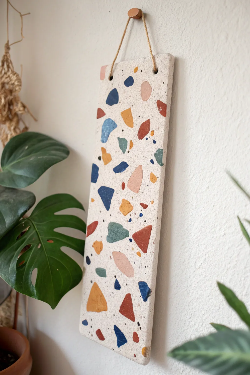 Terrazzo-style clay slab wall art that adds bold color to a calm, minimalist space.