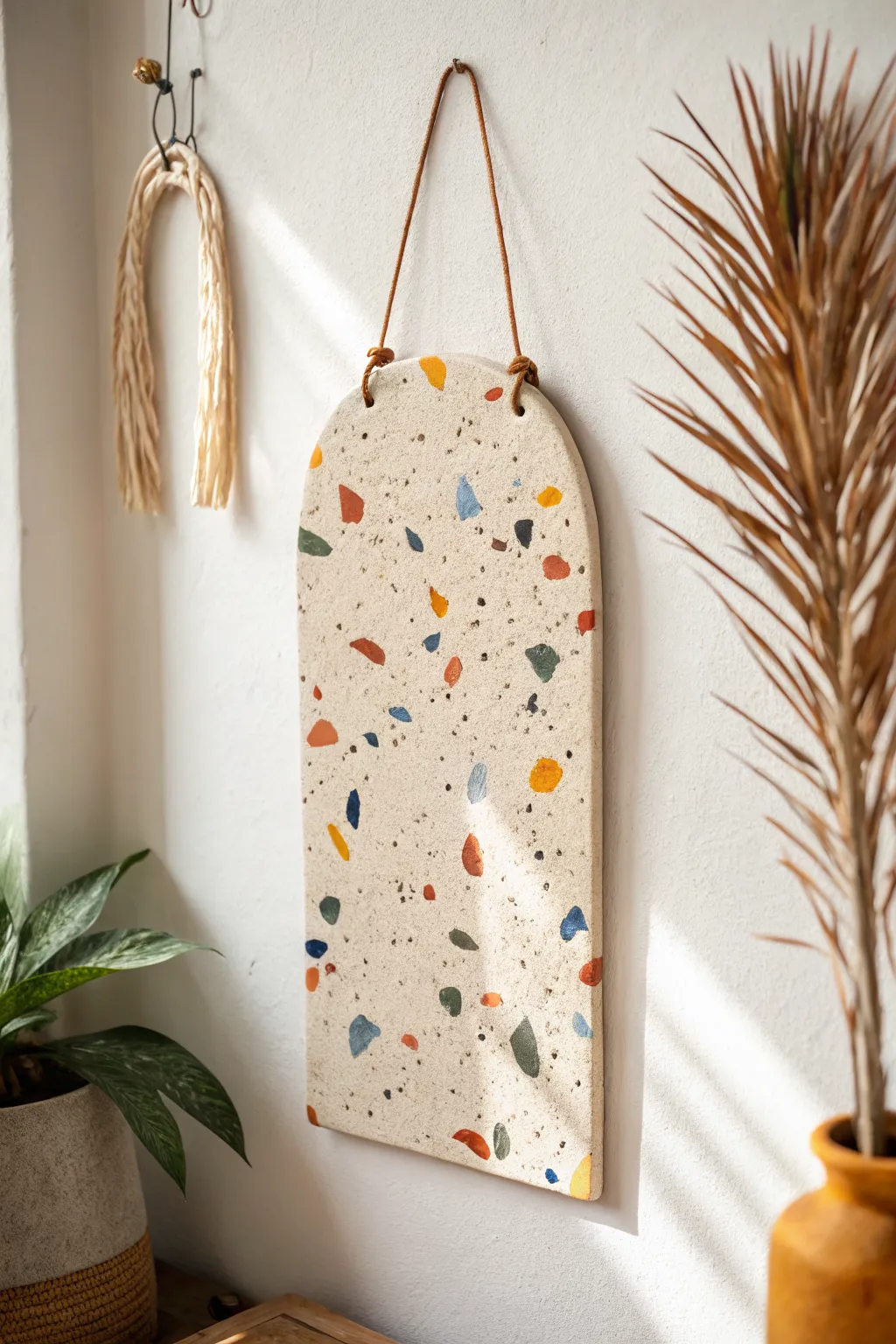 Terrazzo clay statement slab with bold flecks on a neutral base for modern wall decor