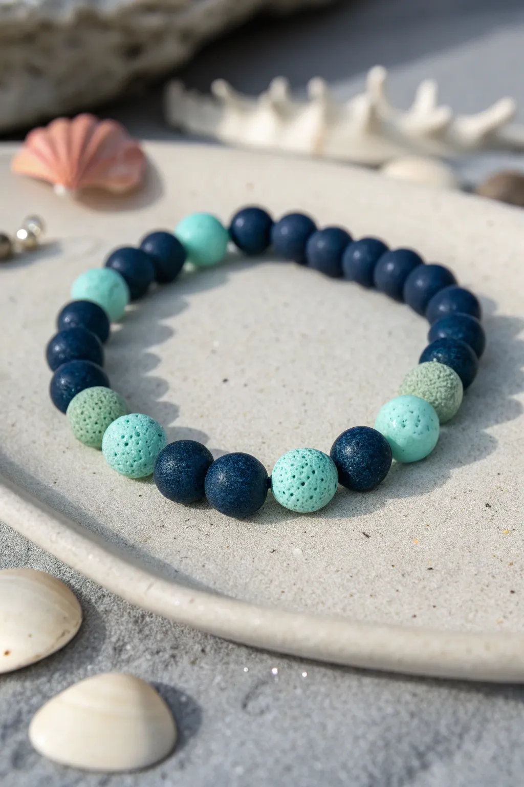 Night-ocean clay bead bracelet in navy and teal, with seafoam beads and subtle glow accents