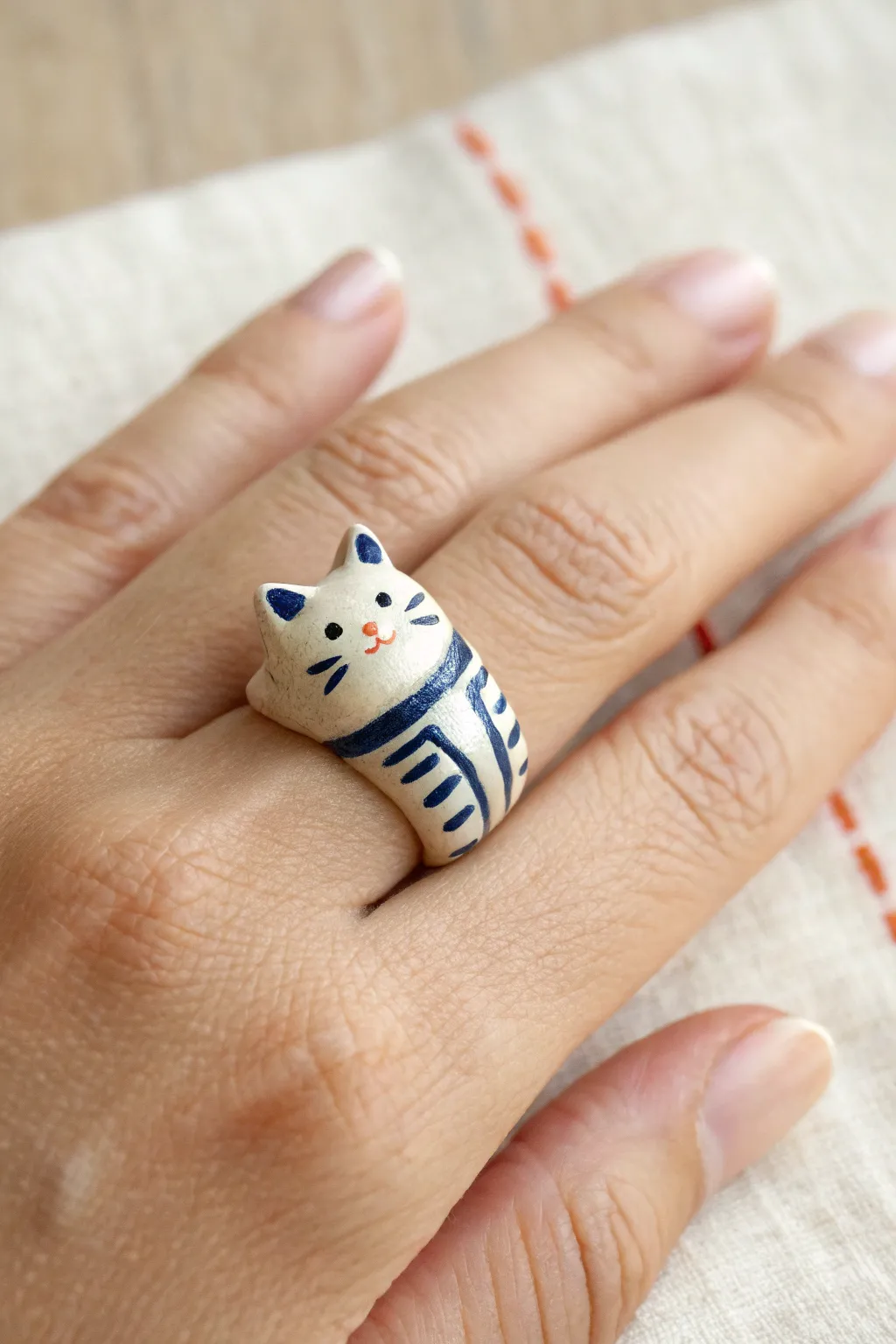 Adorable hugging cat wrap ring with bold stripes, minimalist boho style, and handmade clay charm.