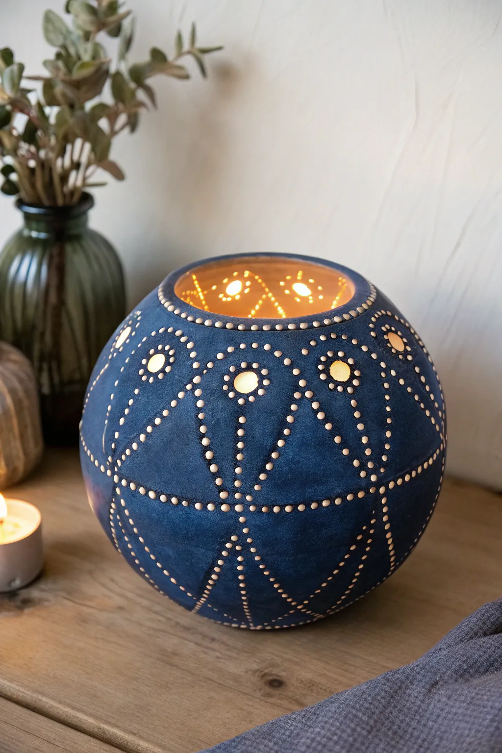 Constellation dot luminary from a simple double pinch pot, cozy glow and bold indigo contrast.