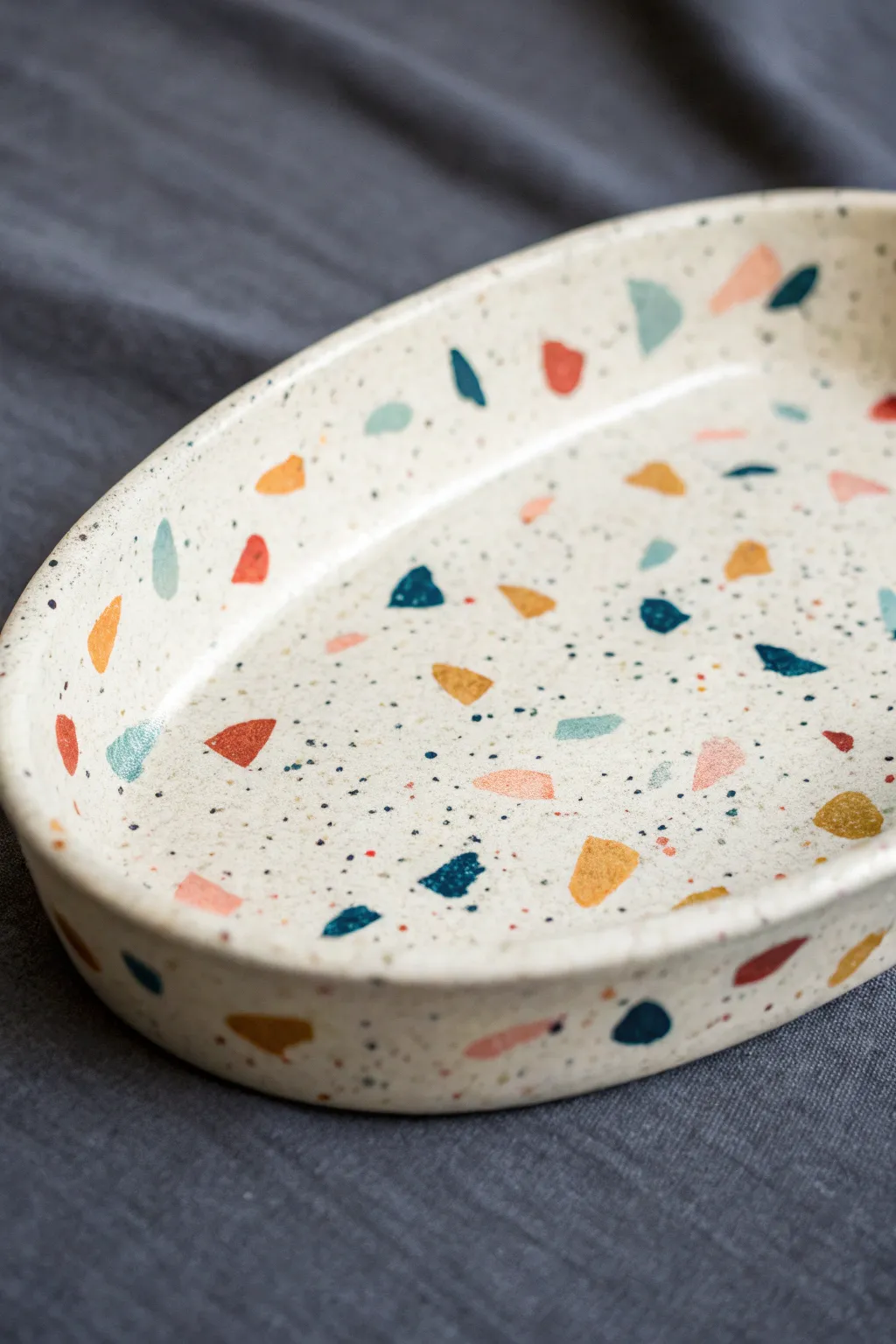 Minimal oval catch-all dish with playful terrazzo speckles, an easy clay upgrade for any room.