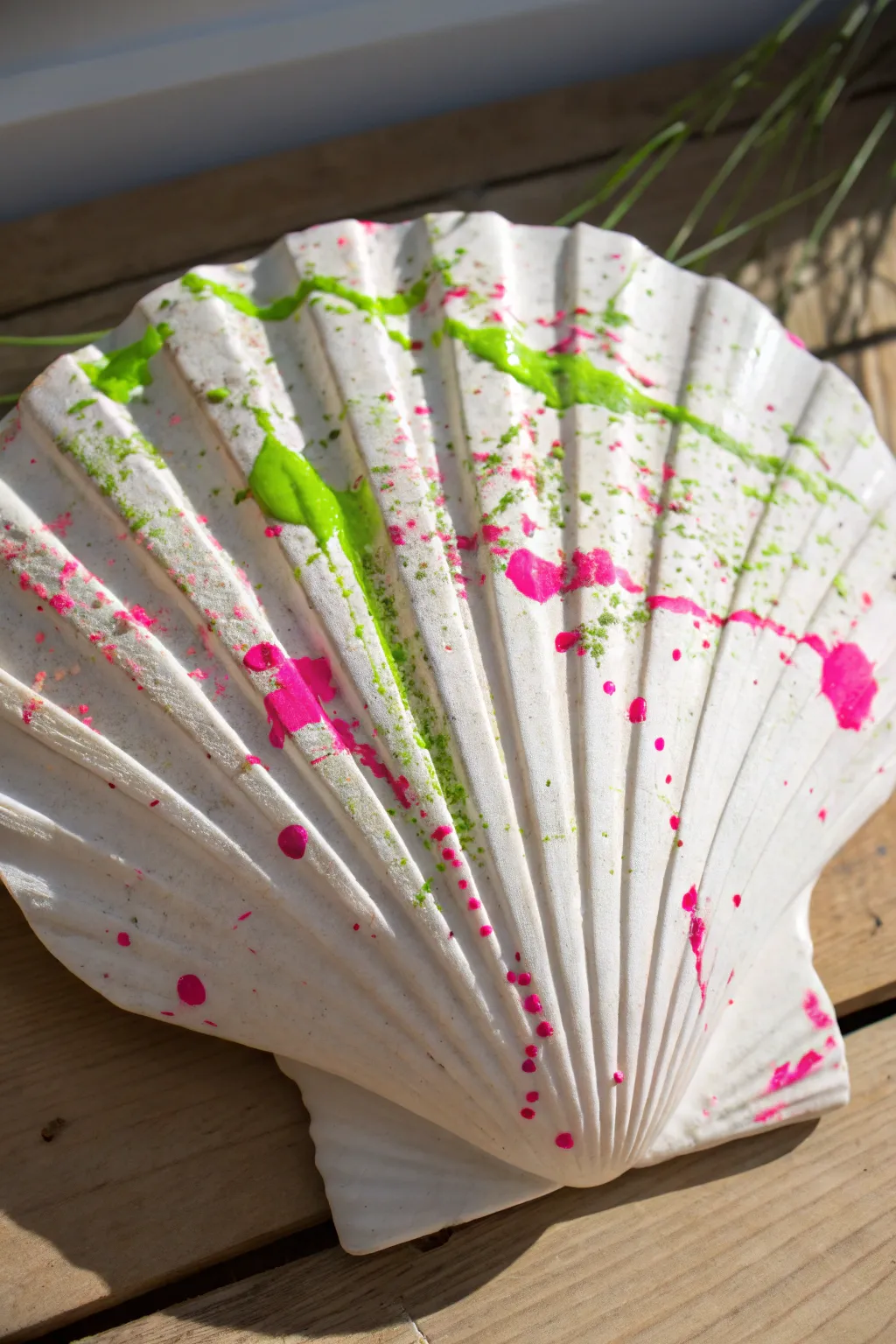 Transform plain shells into modern art with this vibrant neon splatter paint technique.