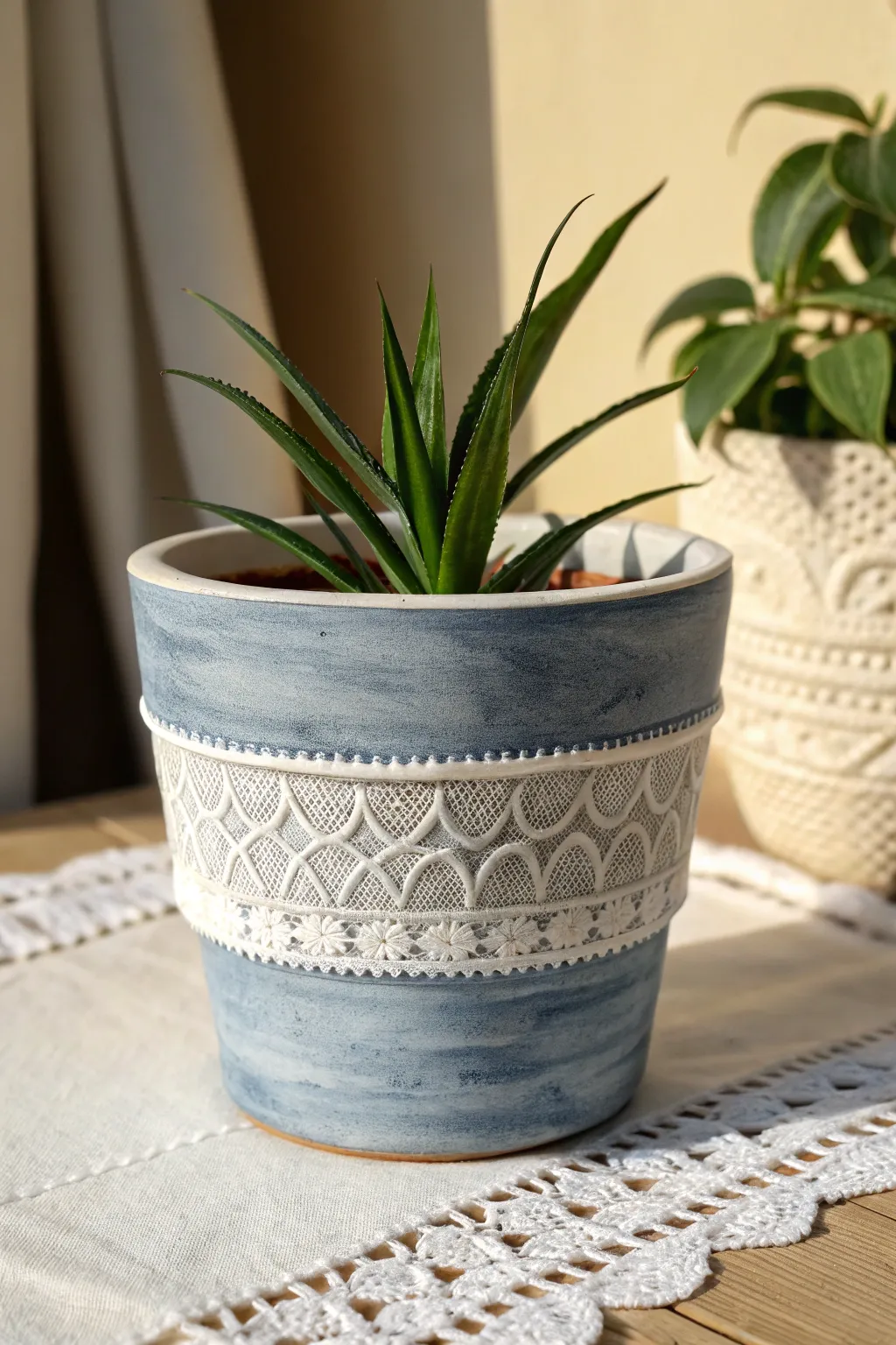 Lace-imprinted band and deep indigo wash bring minimalist boho texture to a simple flower pot.