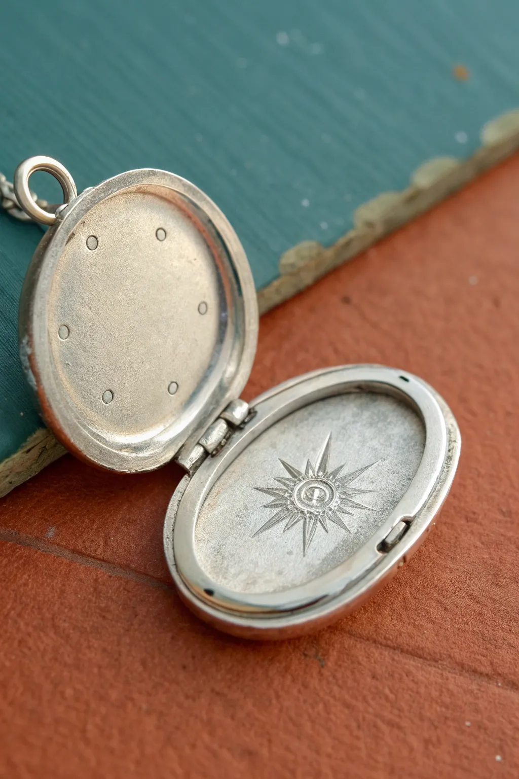 A simple hinged metal clay locket, slightly open to show an easy stamped interior detail.