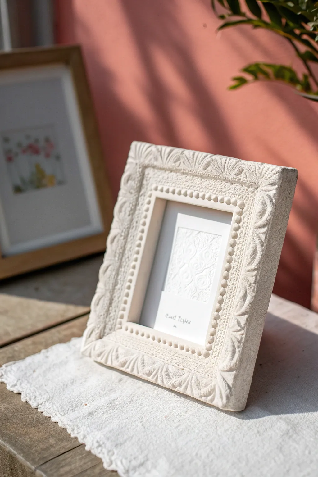 Soft white paper clay frame with lace-imprinted texture, minimalist boho detail for any shelf.