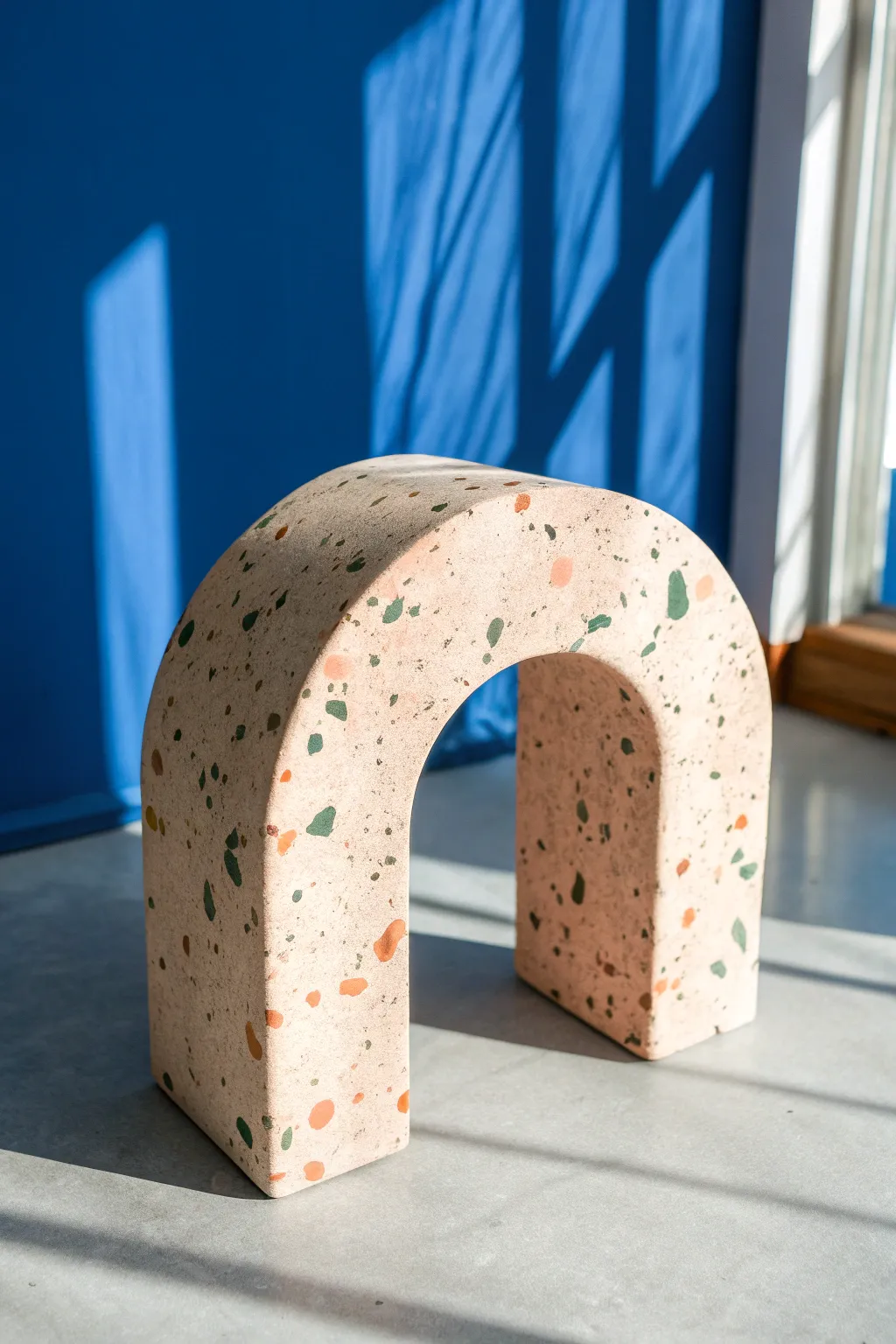 Faux terrazzo plasticine arch desk base in bold color, minimalist Scandinavian-boho decor.