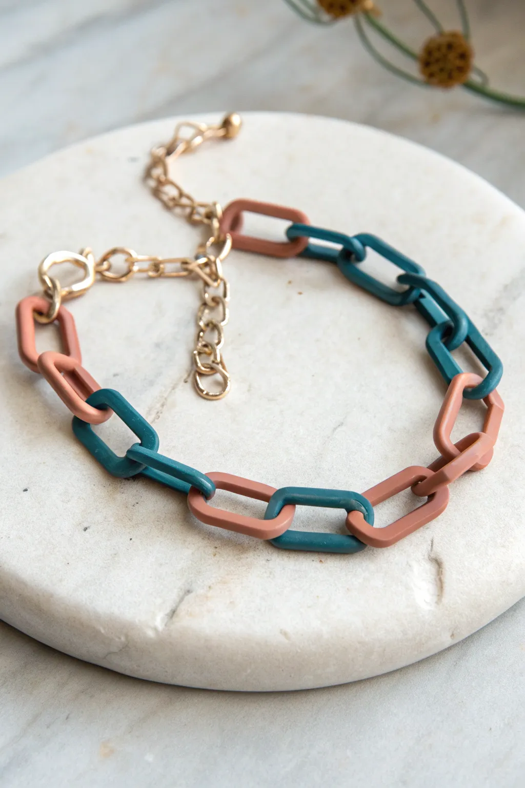 Geometric polymer clay links from extruded shapes, bold colors on soft stone, minimalist and chic.