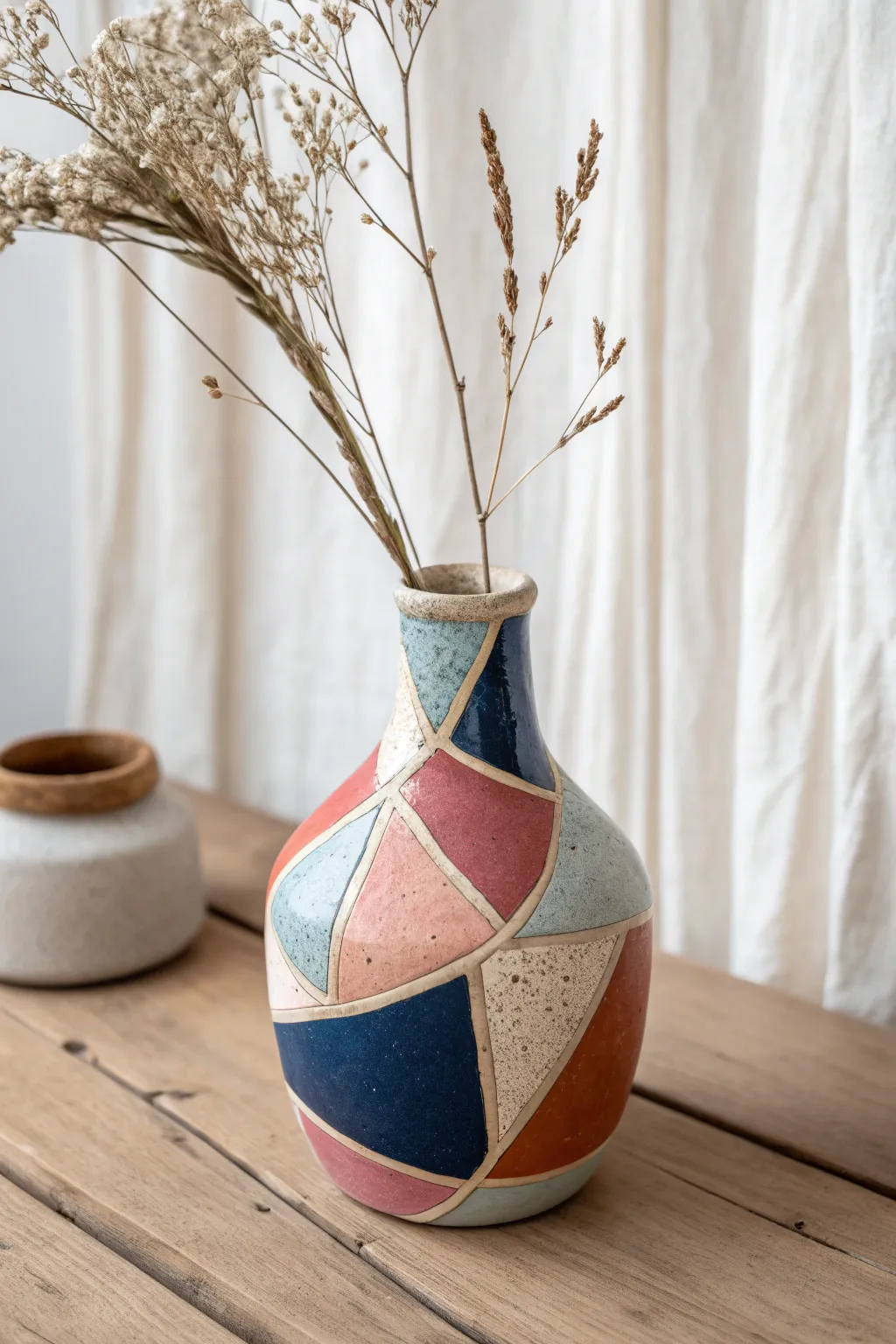 Mini polymer clay slab bud vase with bold color blocking and a single dried stem, minimalist chic.