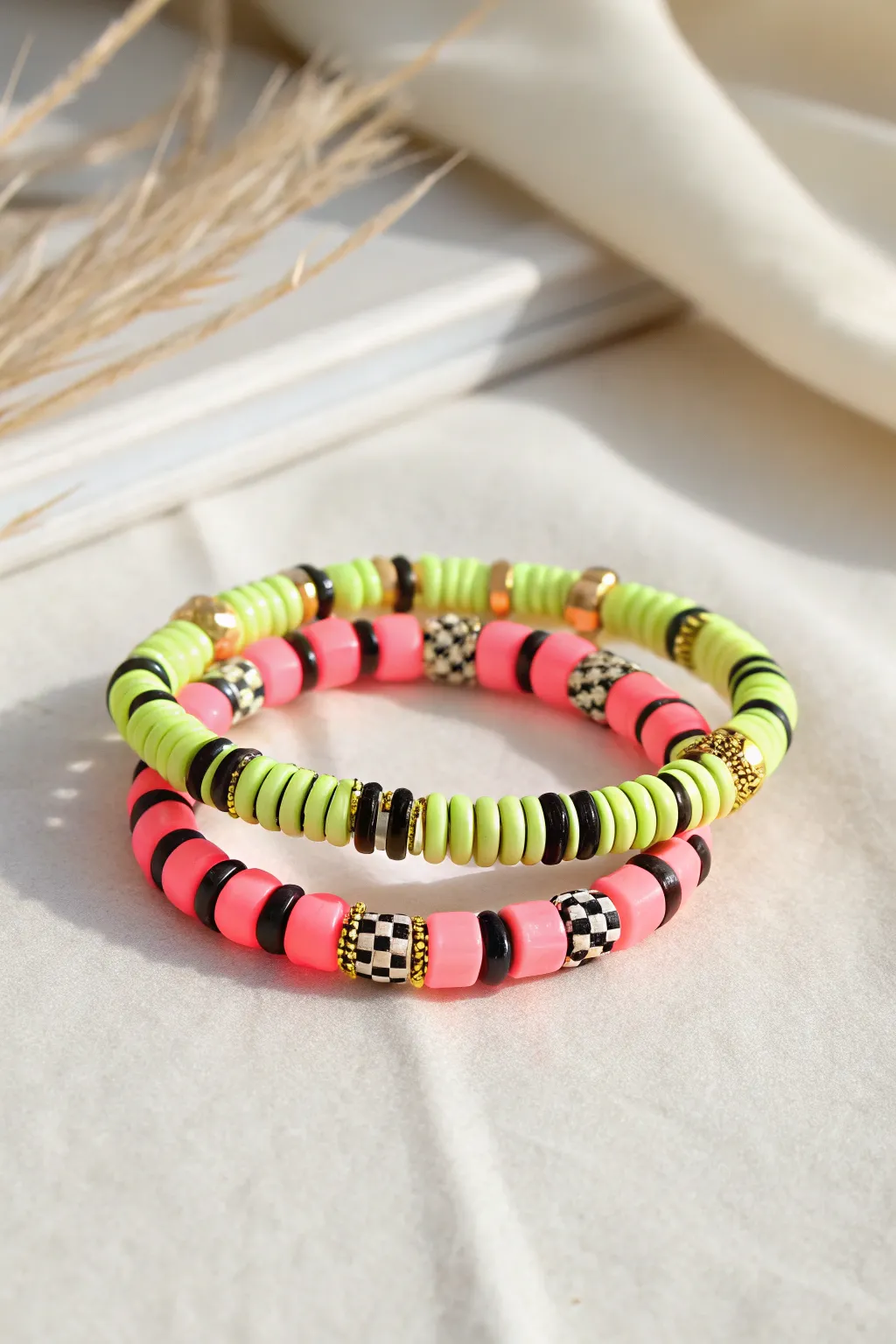 Neon heishi meets crisp black-and-white, finished with gold spacers for a preppy luxe stack.