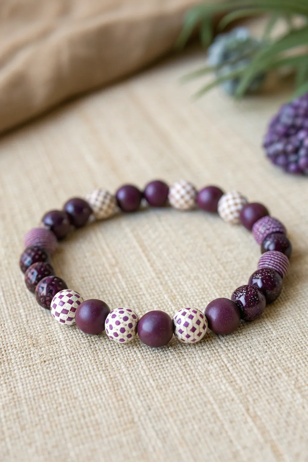 Micro-checker purple clay bead bracelet flat-lay, Scandinavian minimalism with boho warmth.