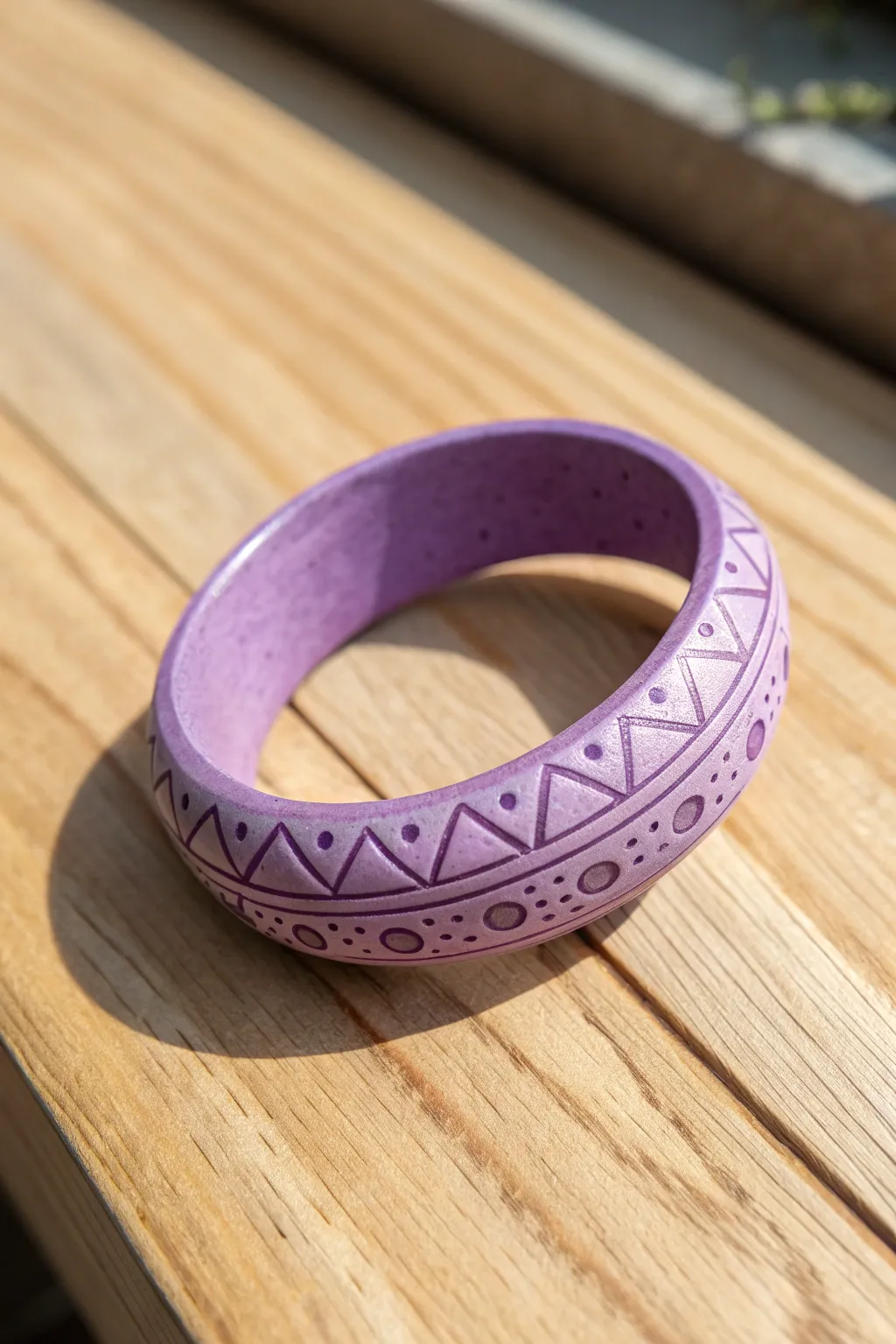 Minimal purple clay bangle with an easy stamped pattern, styled on warm wood for bold contrast