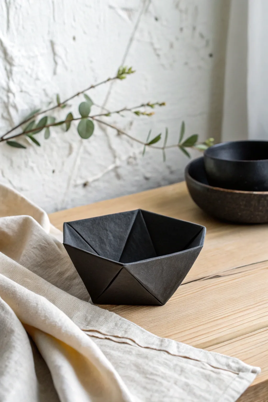 Origami fold clay bowl in matte black, minimalist and bold for a modern boho shelf