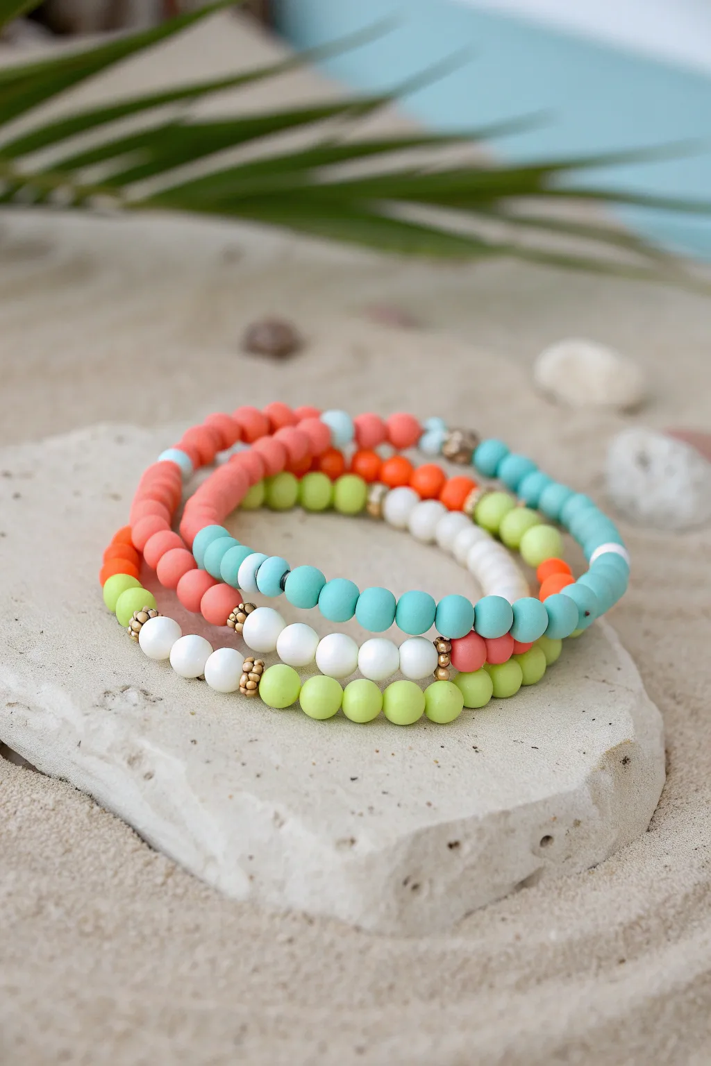 Neon-and-white clay bead stack with subtle glow beads for an easy night swim summer vibe